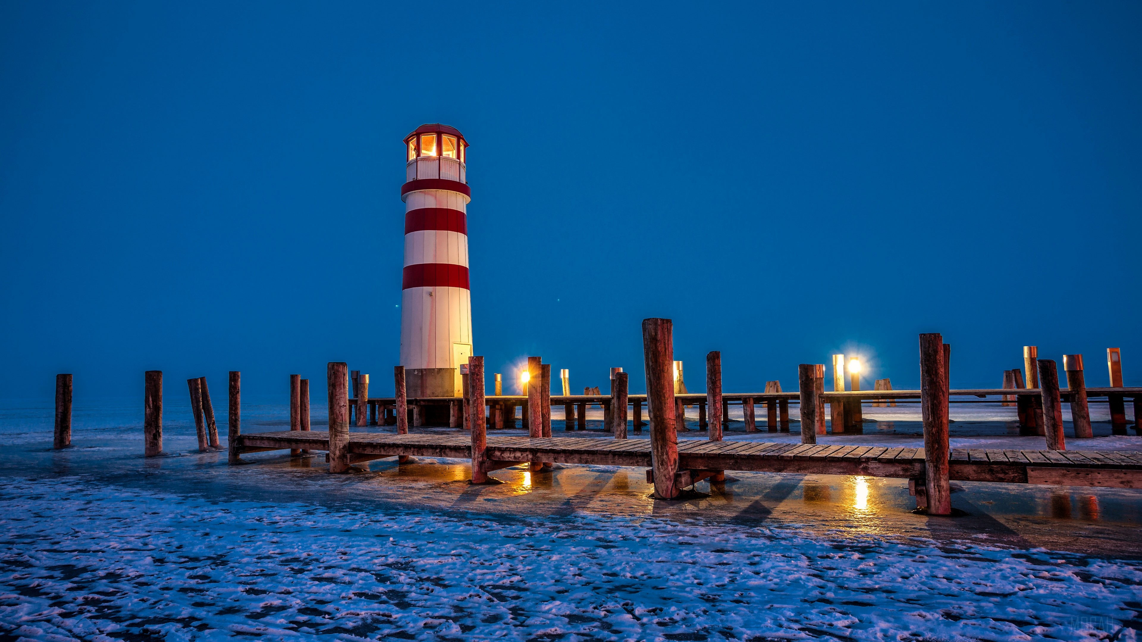 Lighthouse and Pier on Icy Winter Night HD Wallpaper