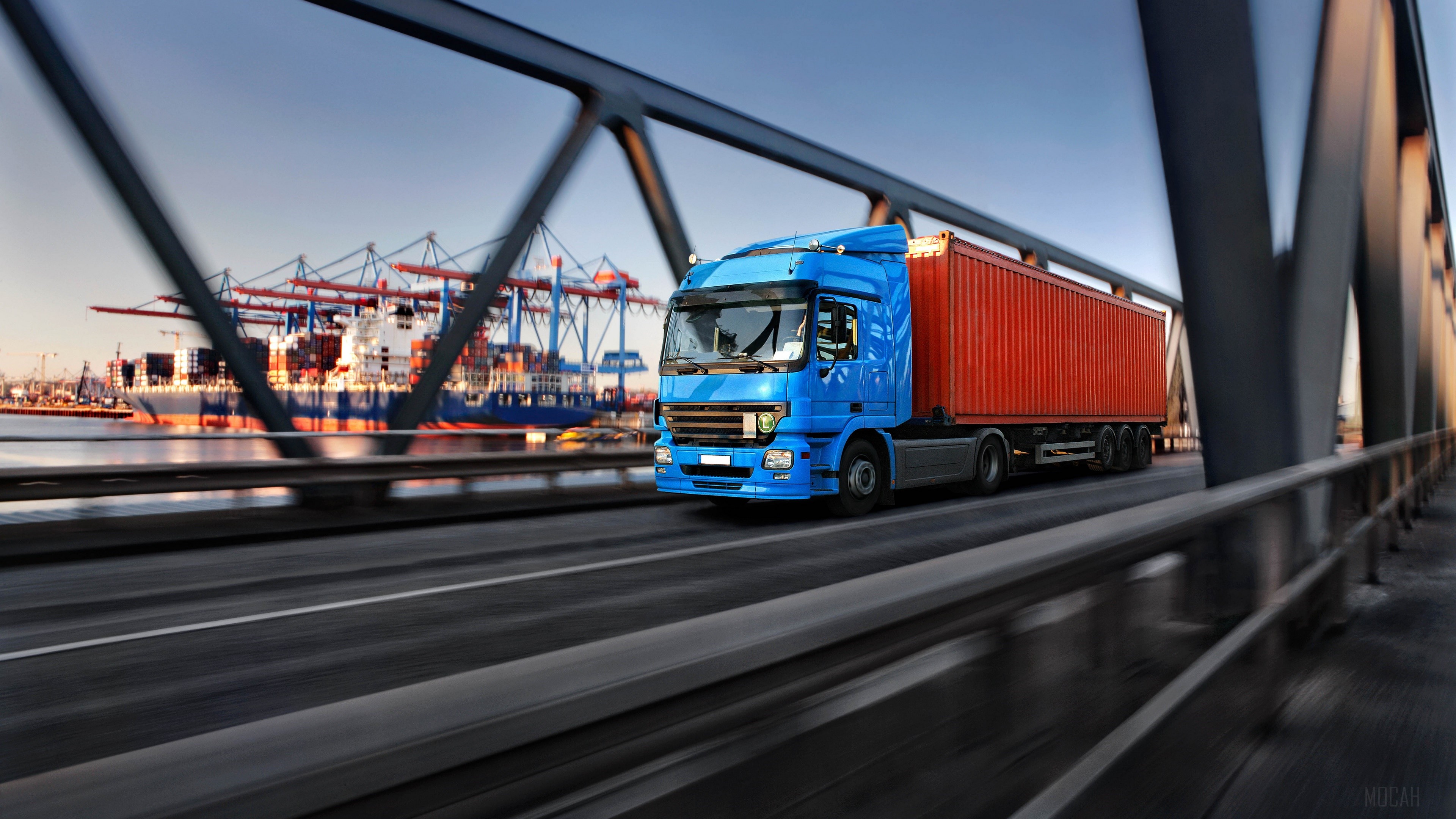 Blue truck with orange container on a bridge 4K HD Wallpaper