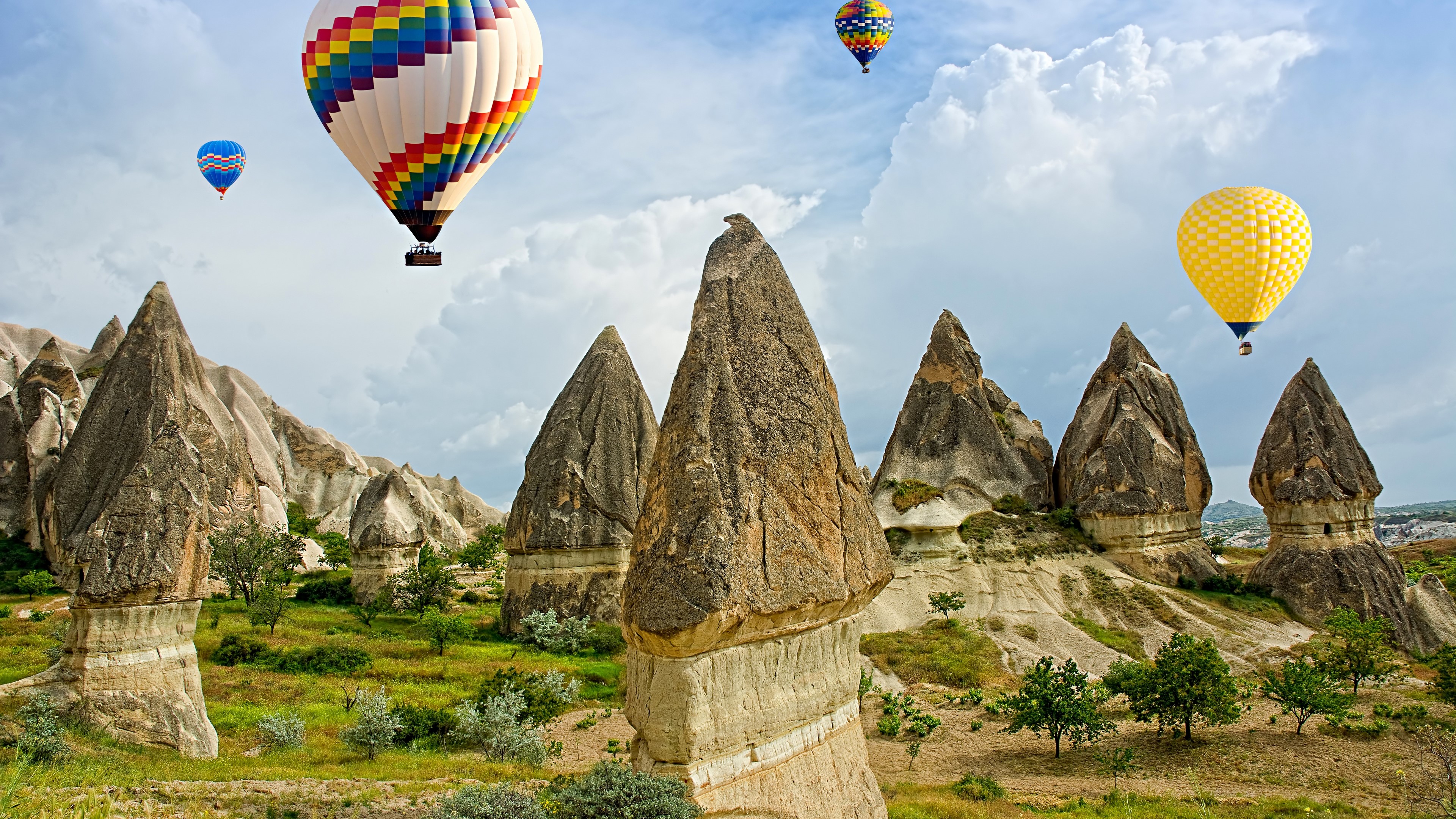 Hot Air Balloons Over Cappadocia Rock Formations 4K HD Wallpaper