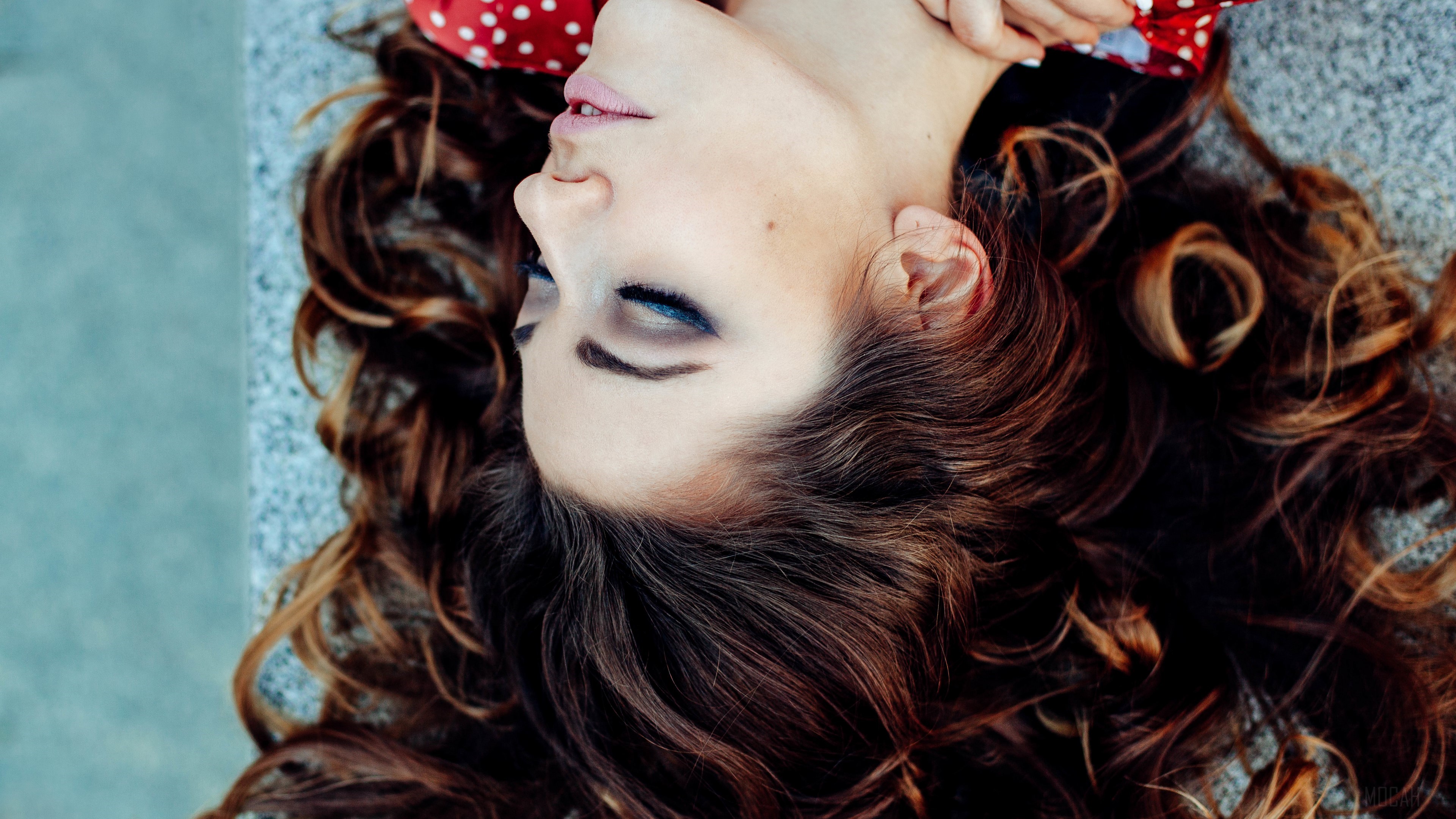 Brunette Woman Lying Down with Red Polka Dot Headband 4K HD Wallpaper