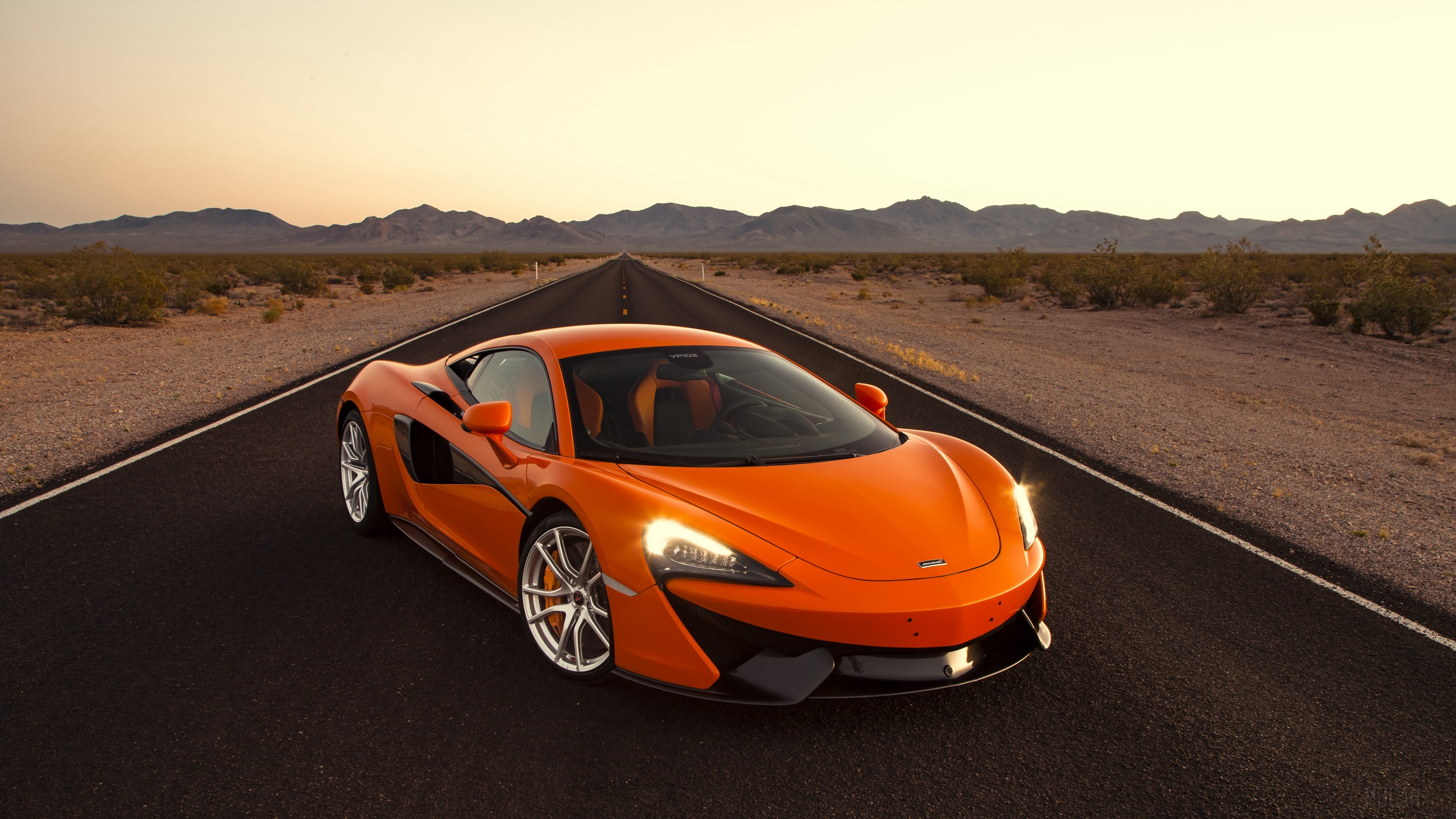 Orange McLaren 570S Supercar on Desert Road 4K HD Wallpaper
