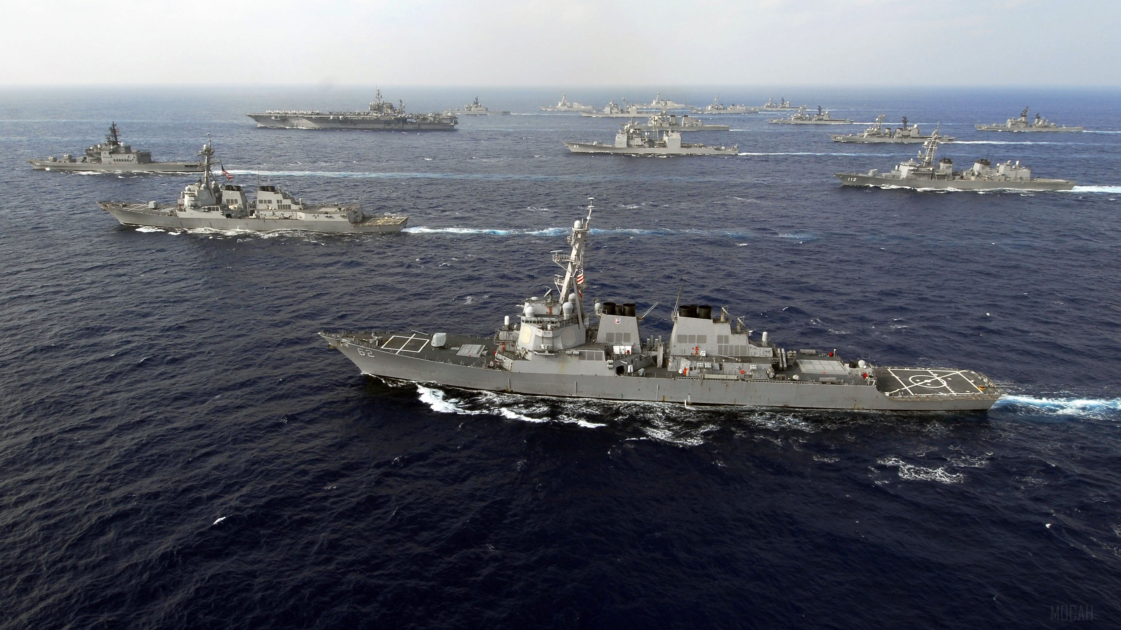 Naval fleet with aircraft carrier and destroyers at sea HD Wallpaper
