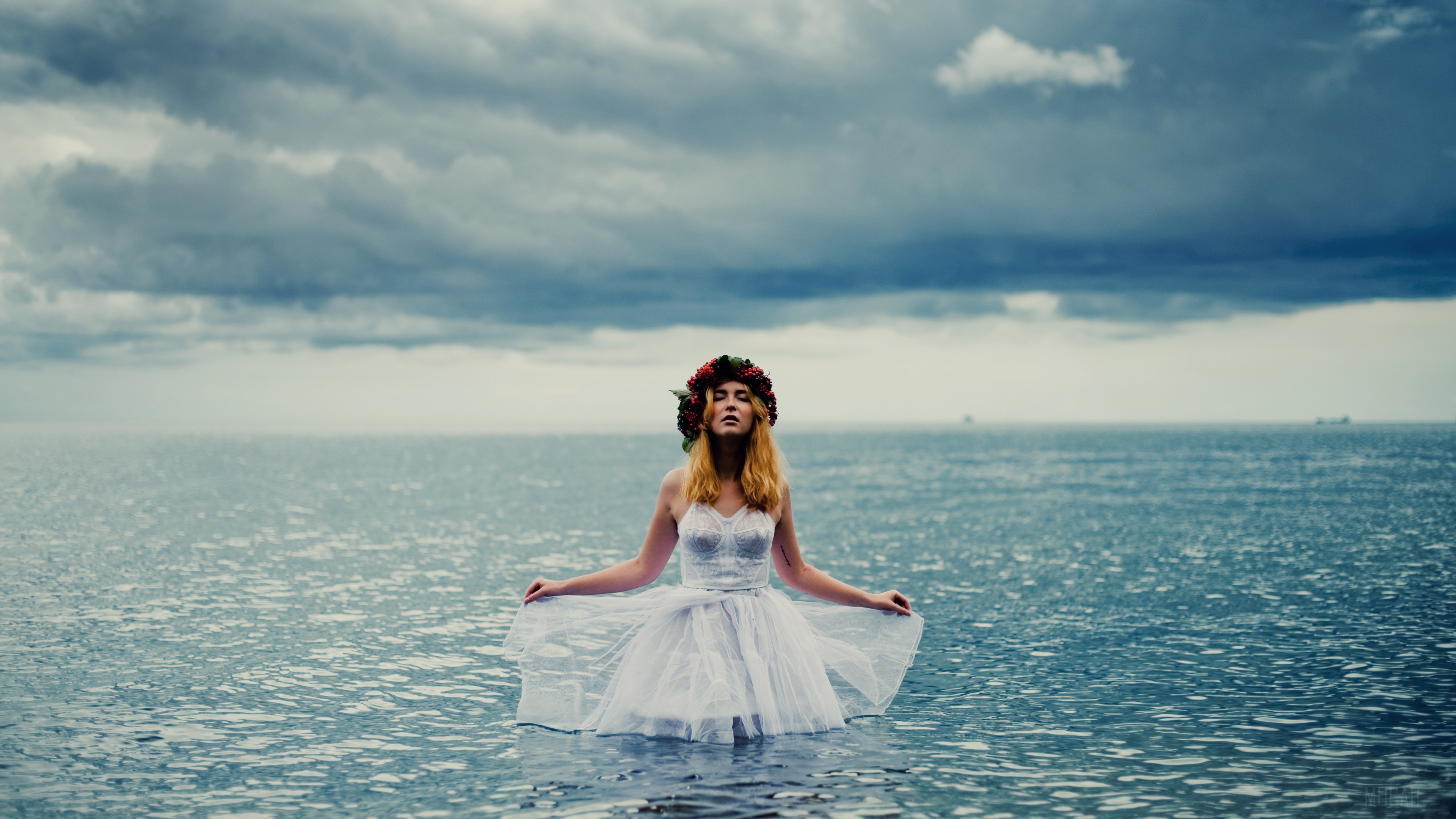 Woman in white dress with flower crown in water HD Wallpaper