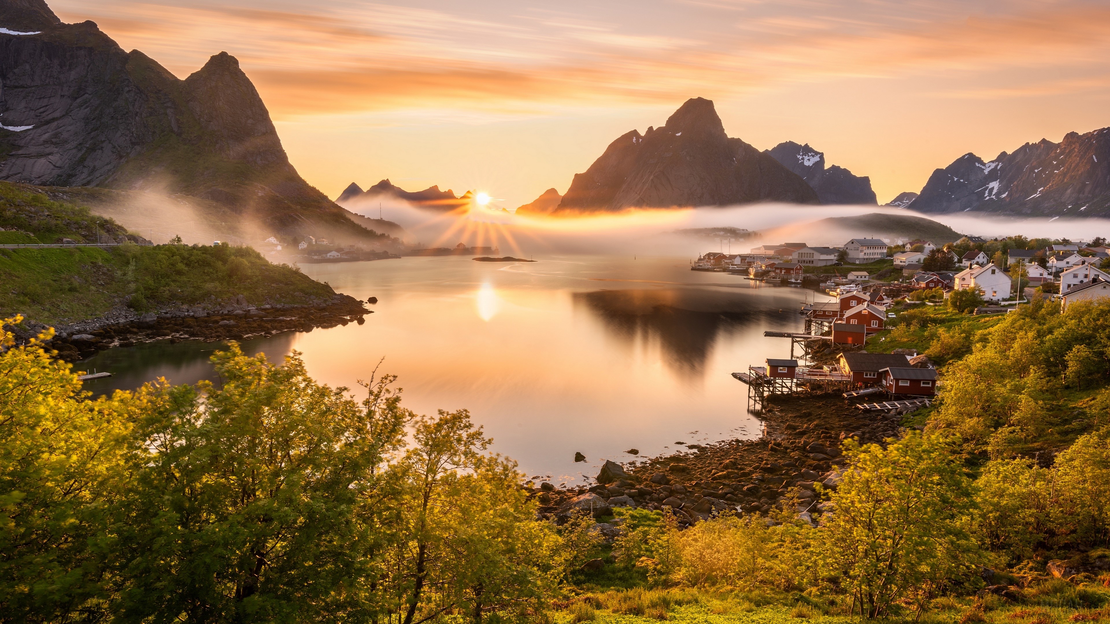 Village by a lake at sunrise with mountains HD Wallpaper