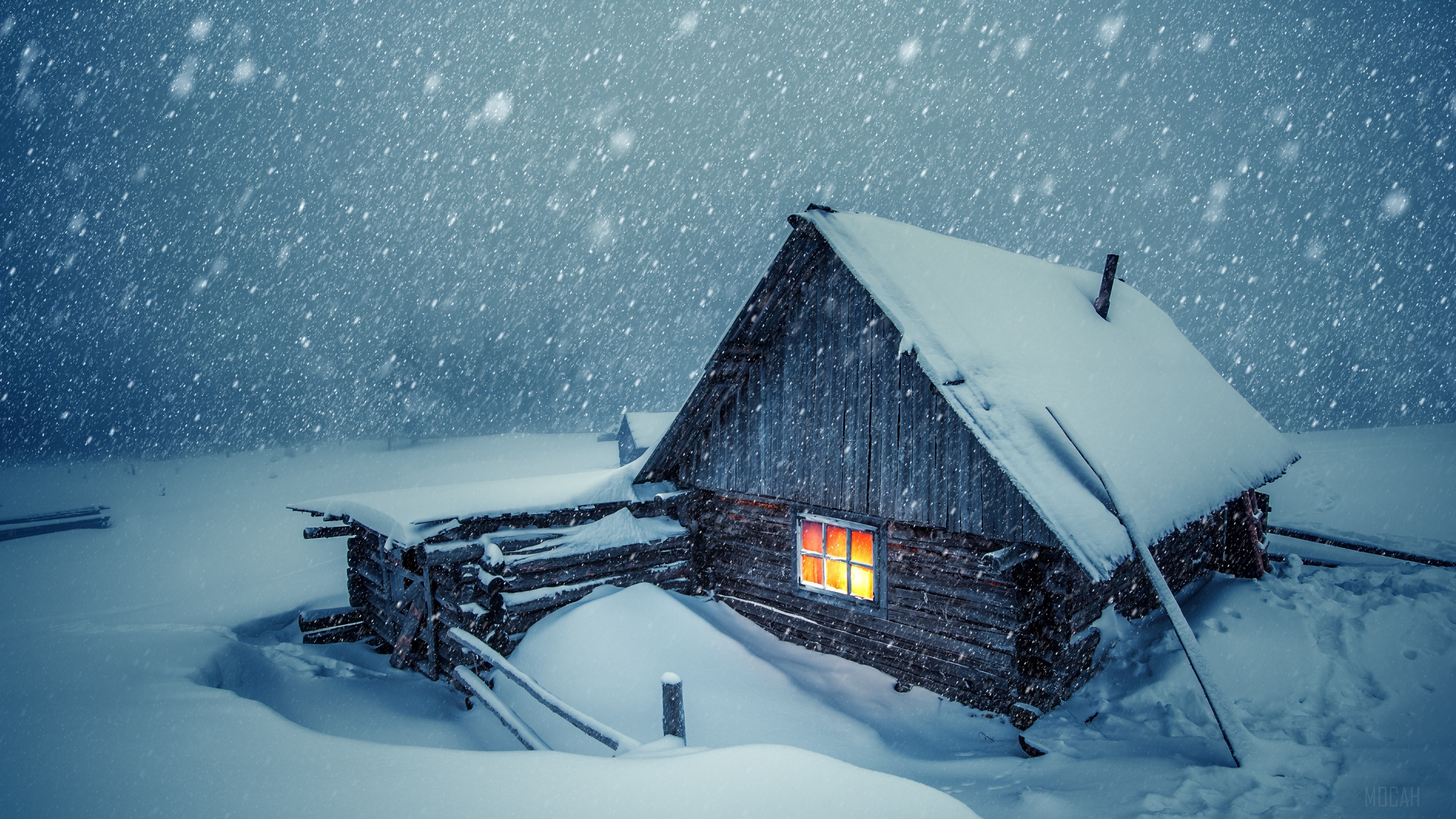 Snow-covered Cabin with Warm Light at Night HD Wallpaper