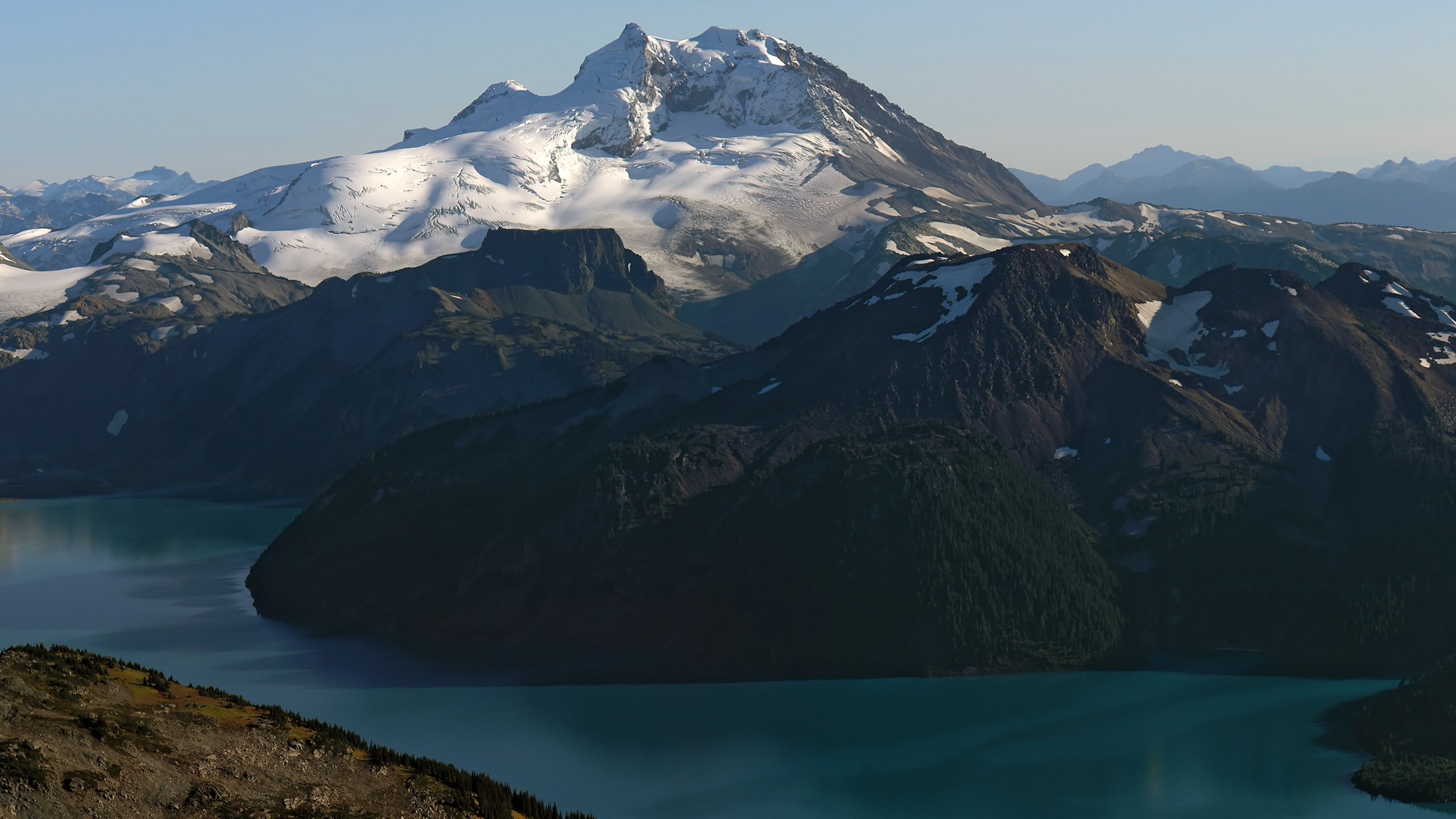 Snow-capped mountains and turquoise lake HD Wallpaper