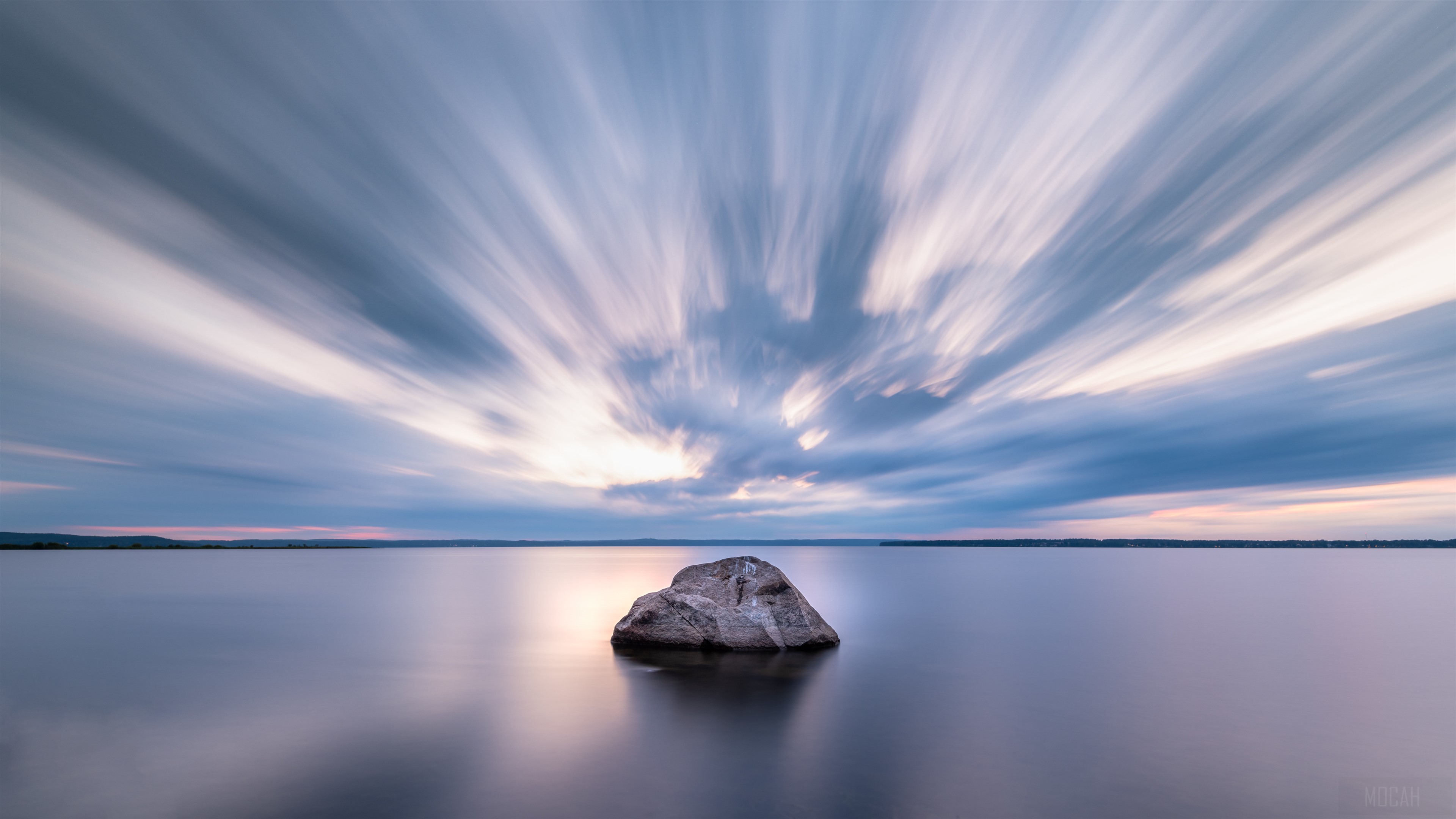 Long Exposure of Rock in Calm Lake Under Streaky Clouds HD Wallpaper