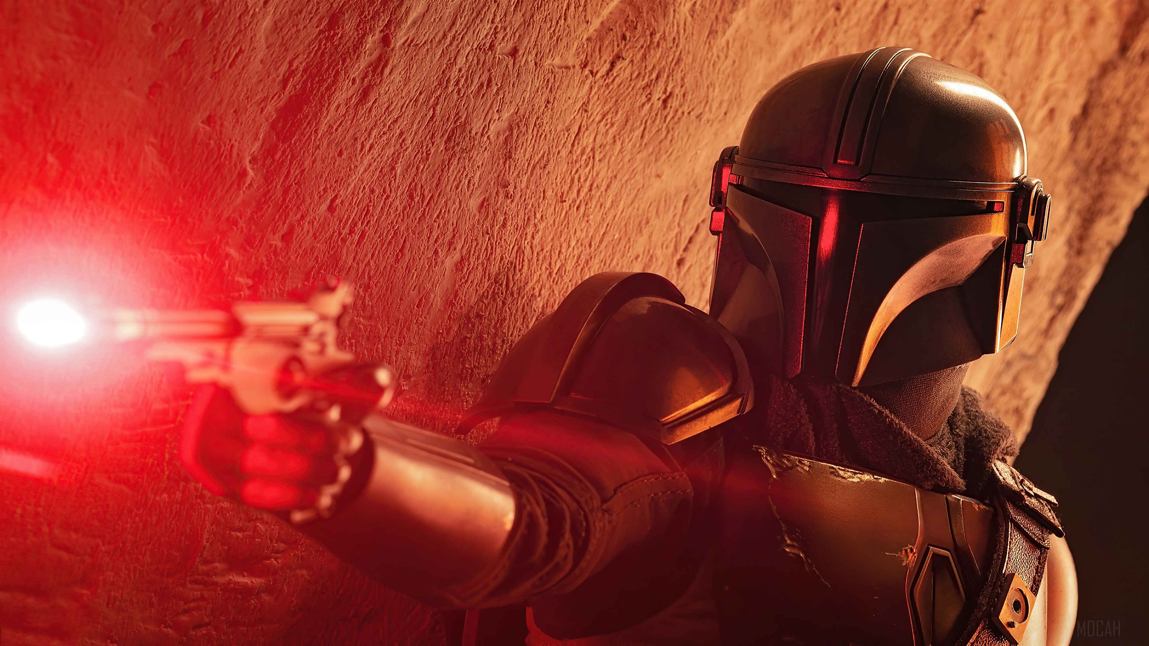 The Mandalorian with a blaster gun HD Wallpaper