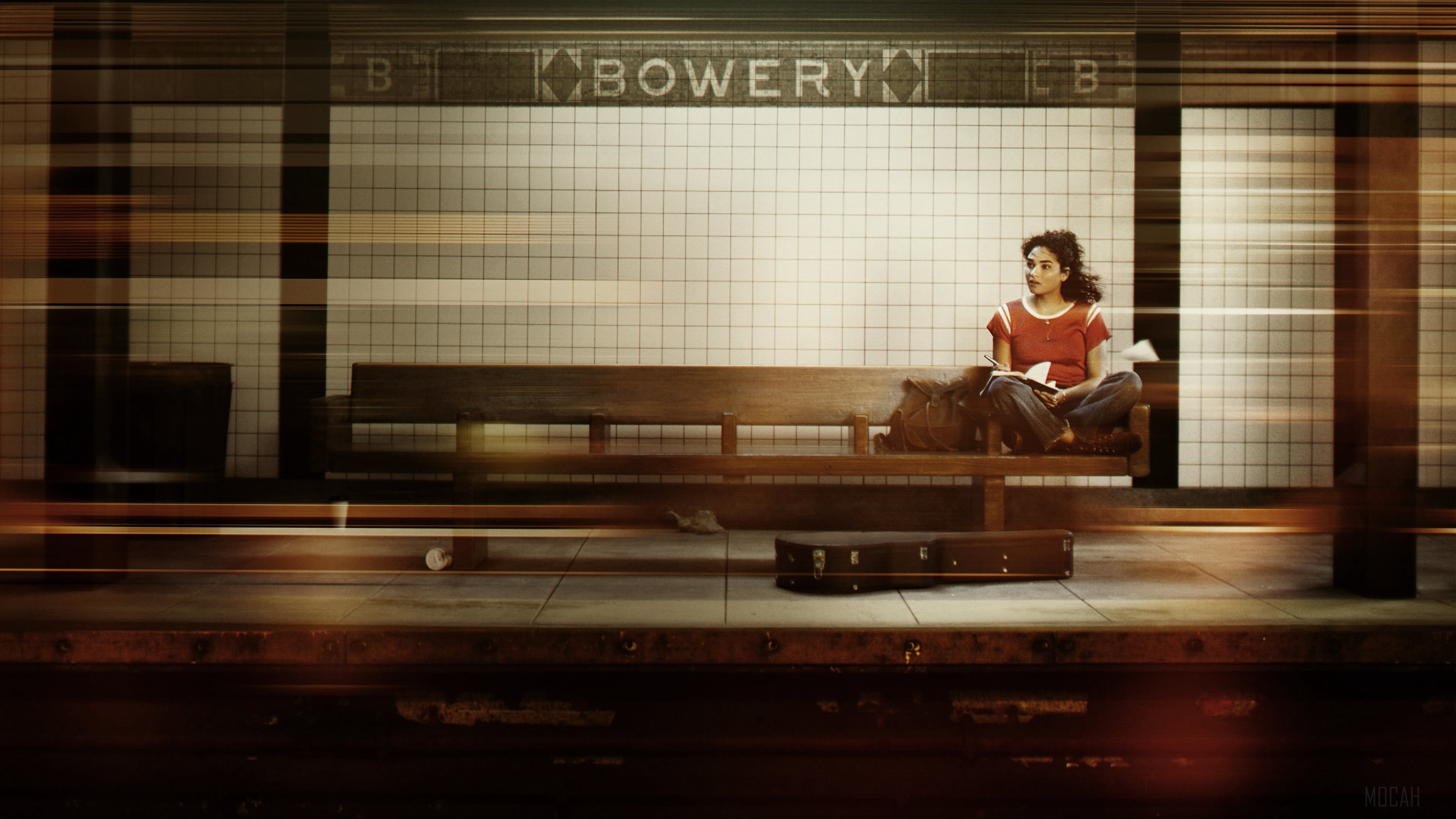 A woman sits on a bench at the Bowery subway station HD Wallpaper