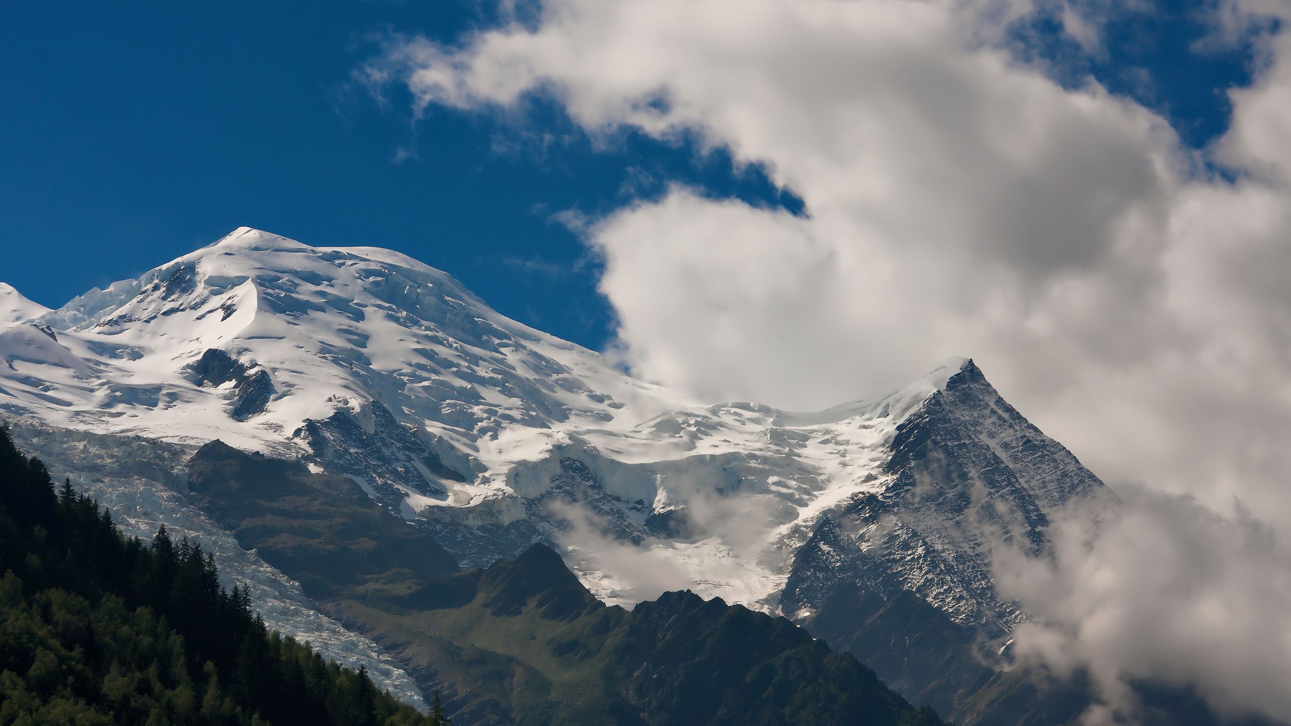 Snow-covered mountains under a blue sky with clouds HD Wallpaper