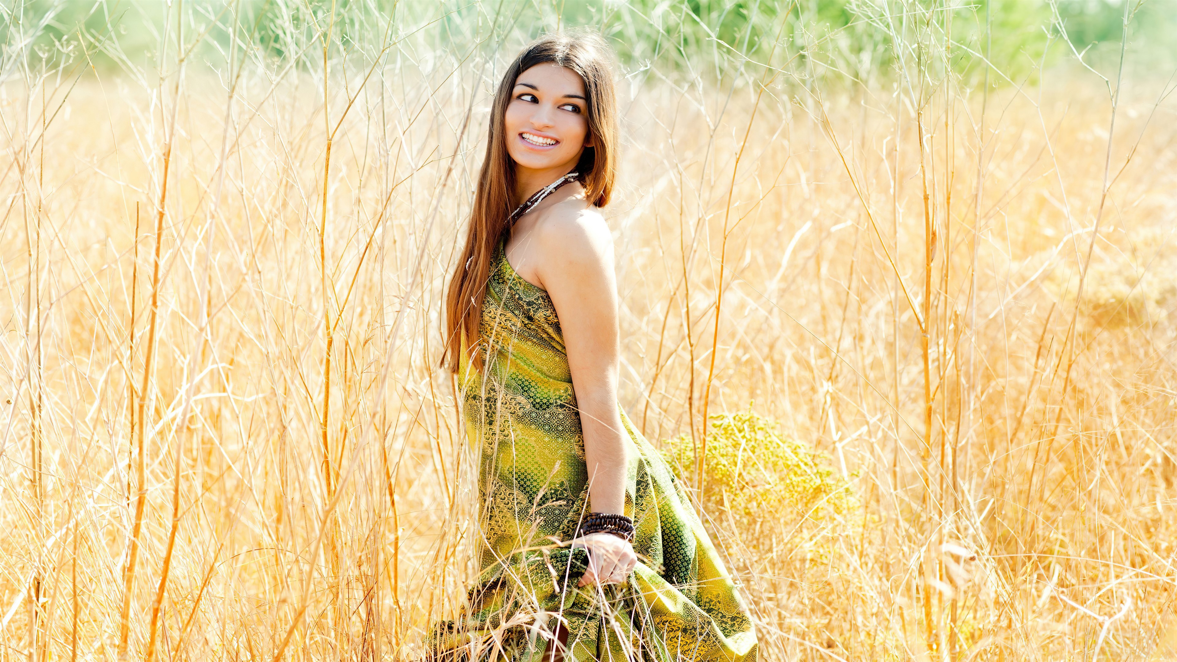 Girl smiling in a field 4K HD Wallpaper