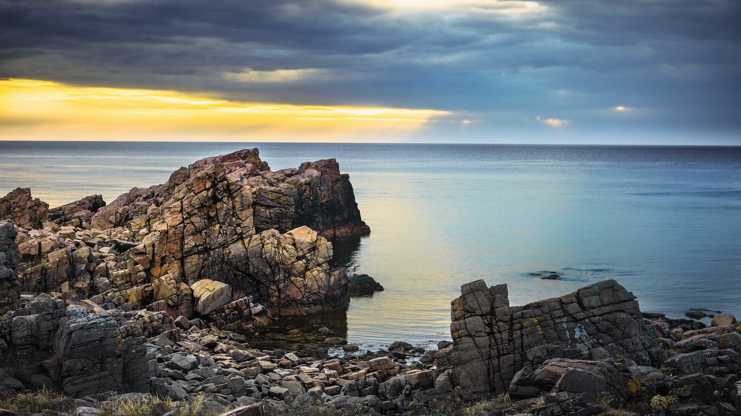 Rocky coastline with ocean and dramatic sky HD Wallpaper