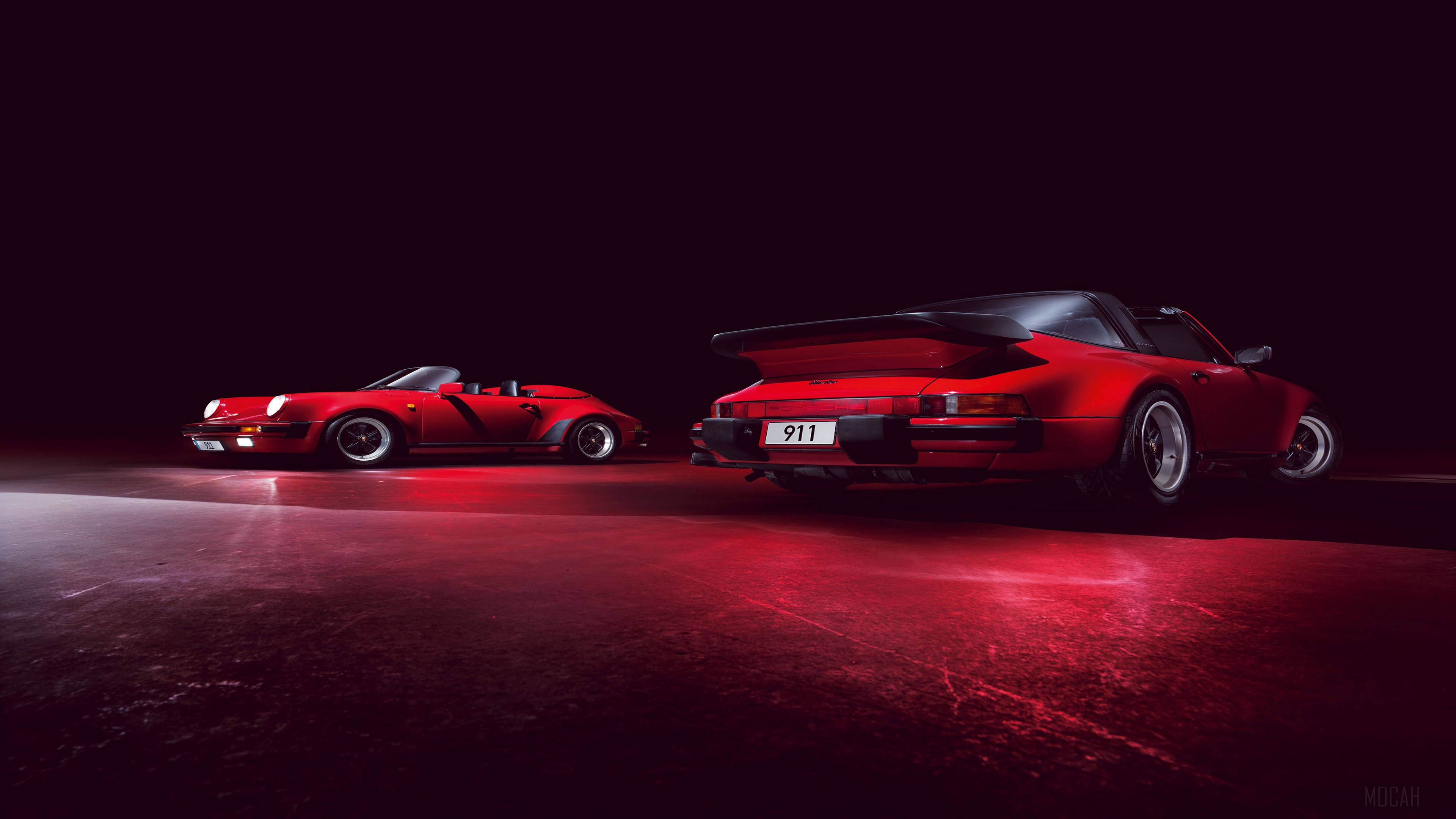Two red Porsche 911 cars in a dark studio HD Wallpaper