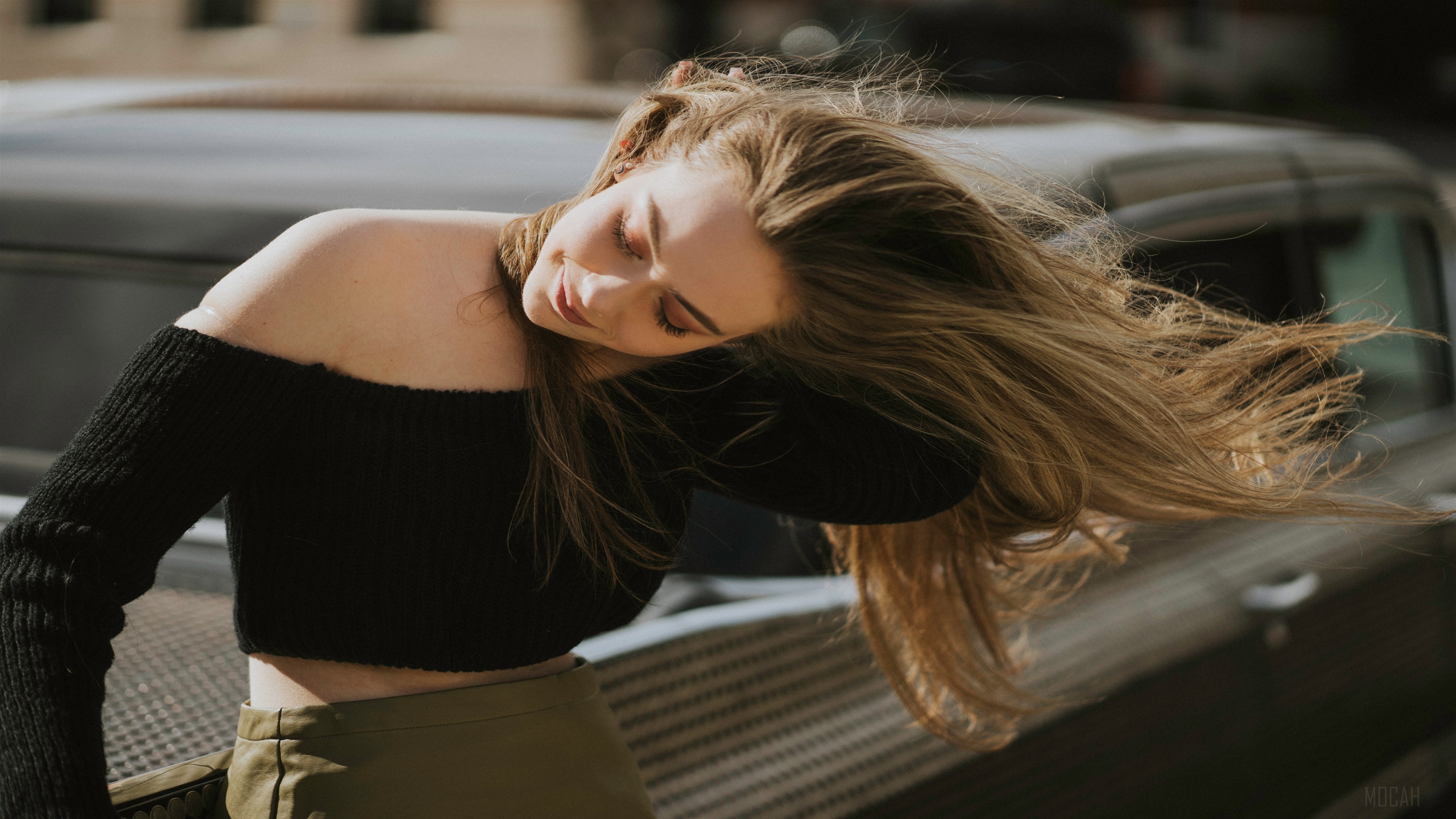 Girl blowing hair near a car HD Wallpaper