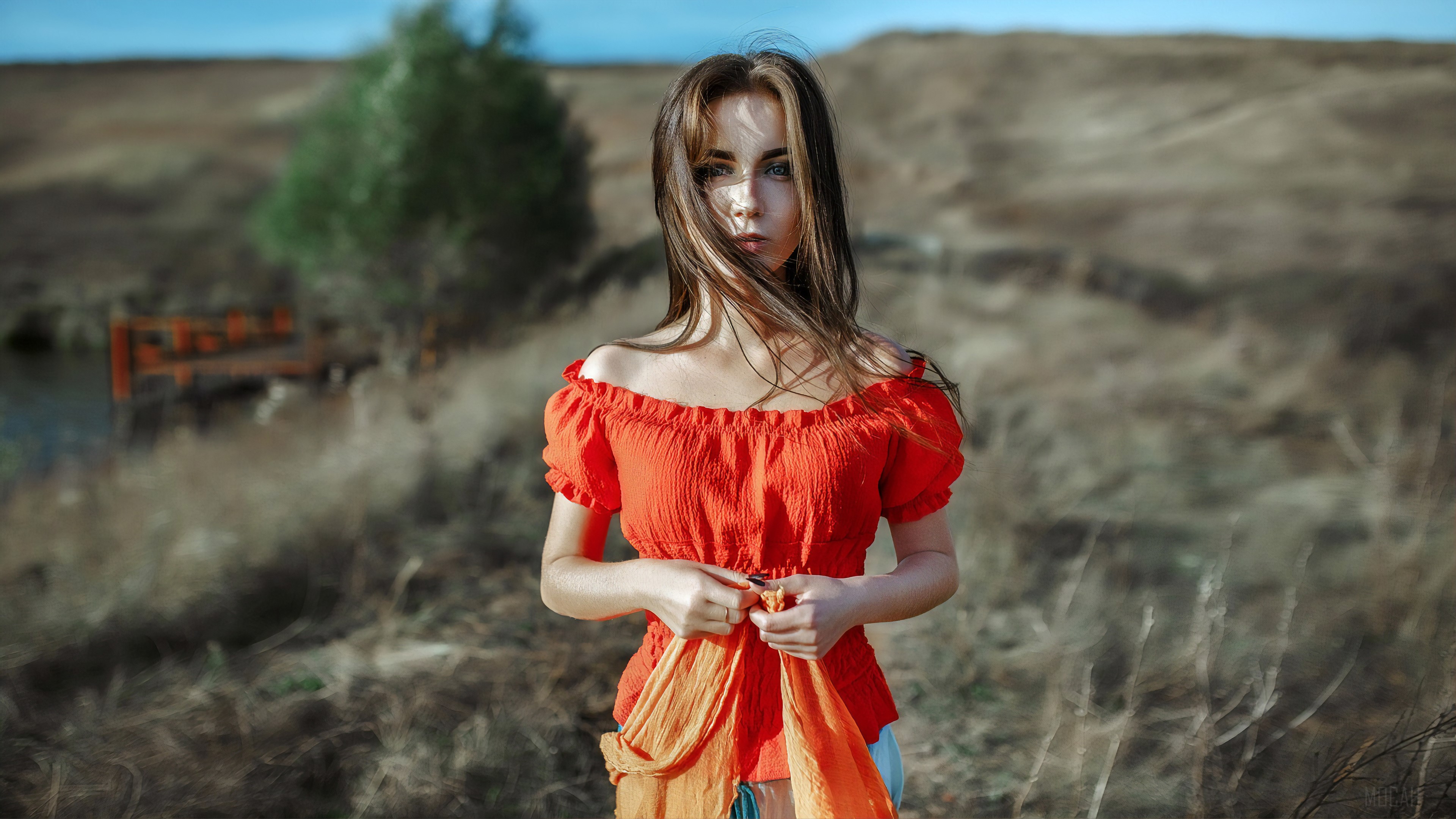 Girl in orange top in field 4k HD Wallpaper