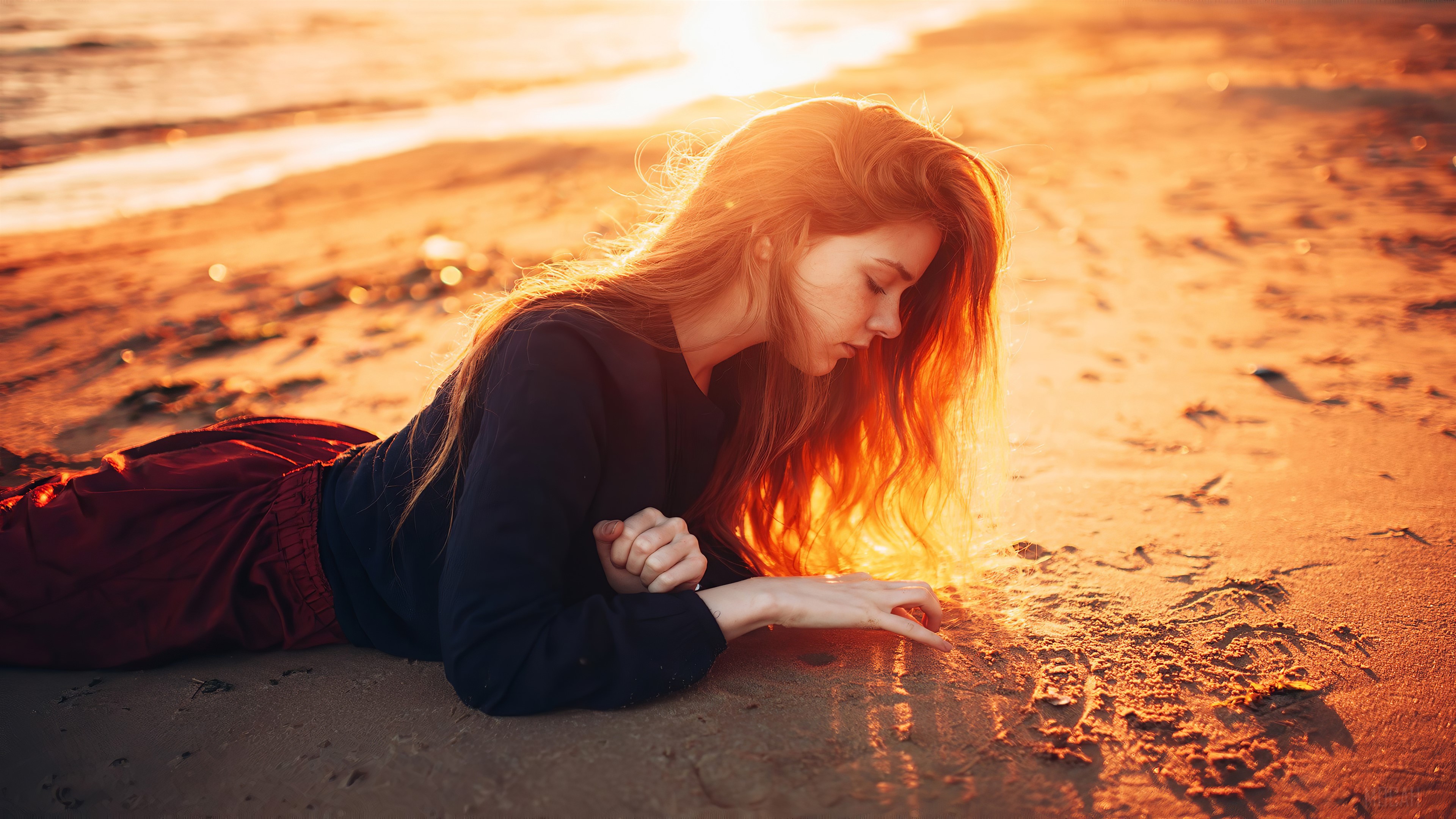 Girl playing with sand on beach at sunset 4K HD Wallpaper