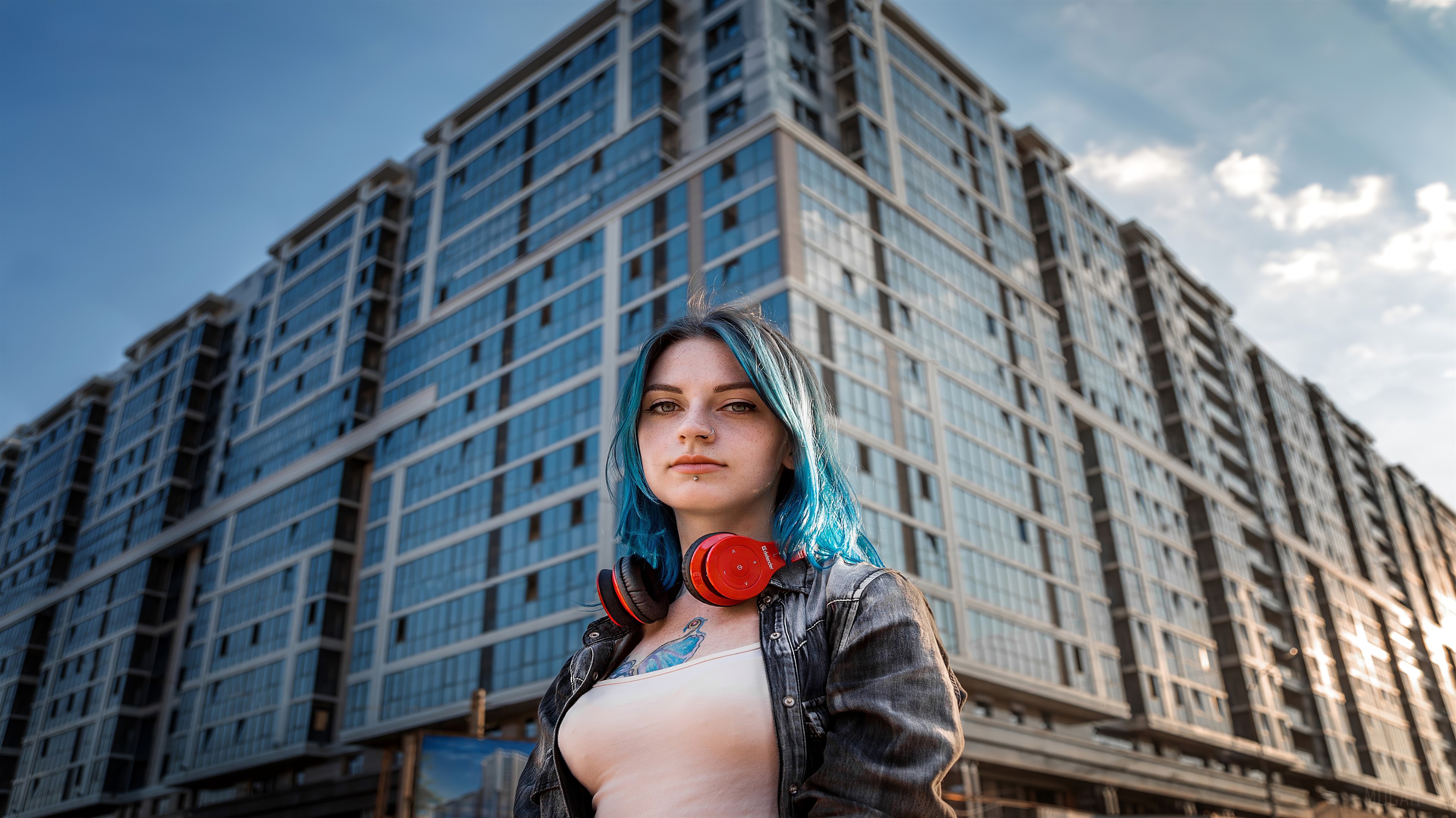 Girl with blue hair and headphones in front of a building HD Wallpaper