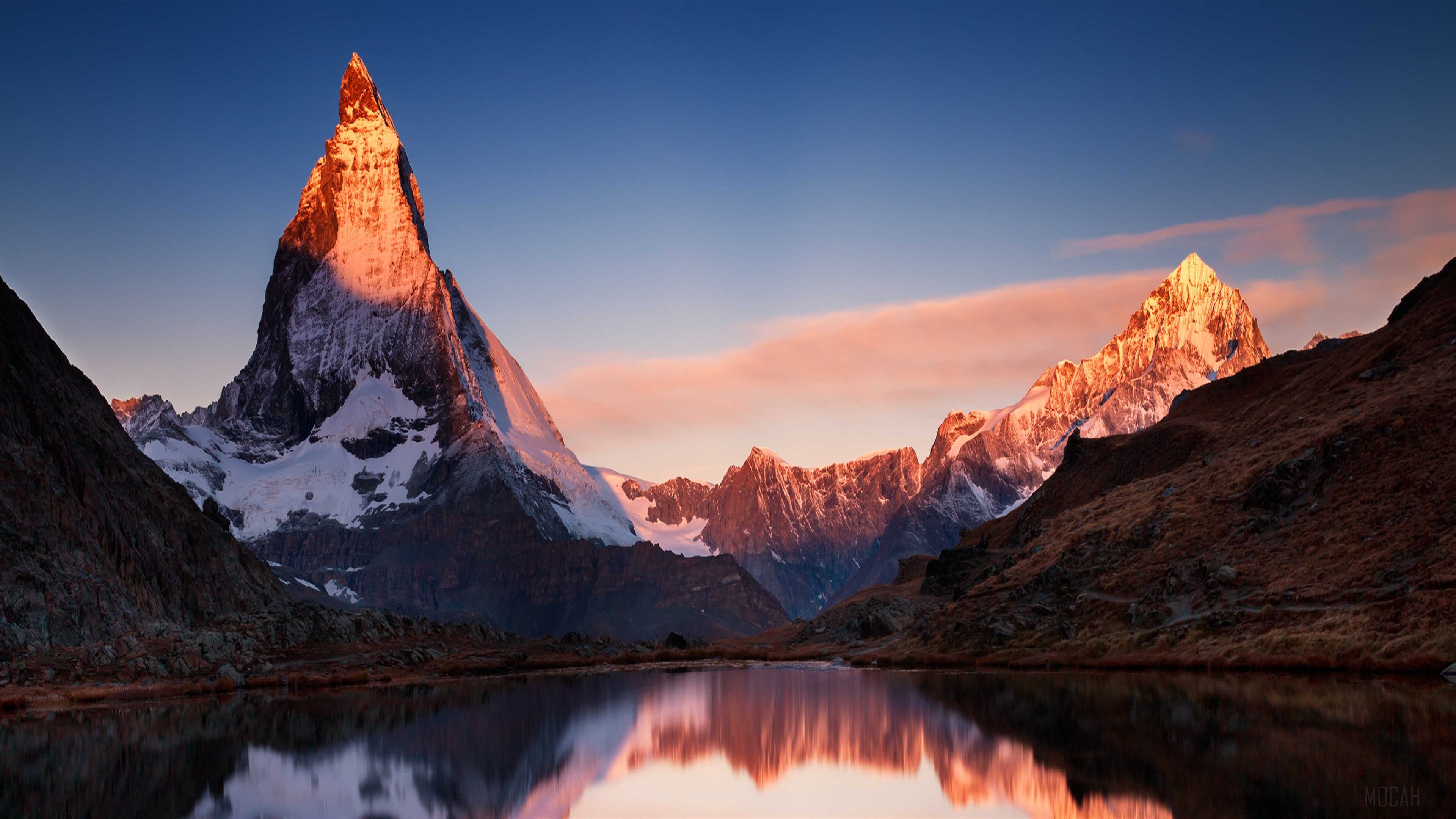 Matterhorn mountain at sunrise reflected in a lake HD Wallpaper