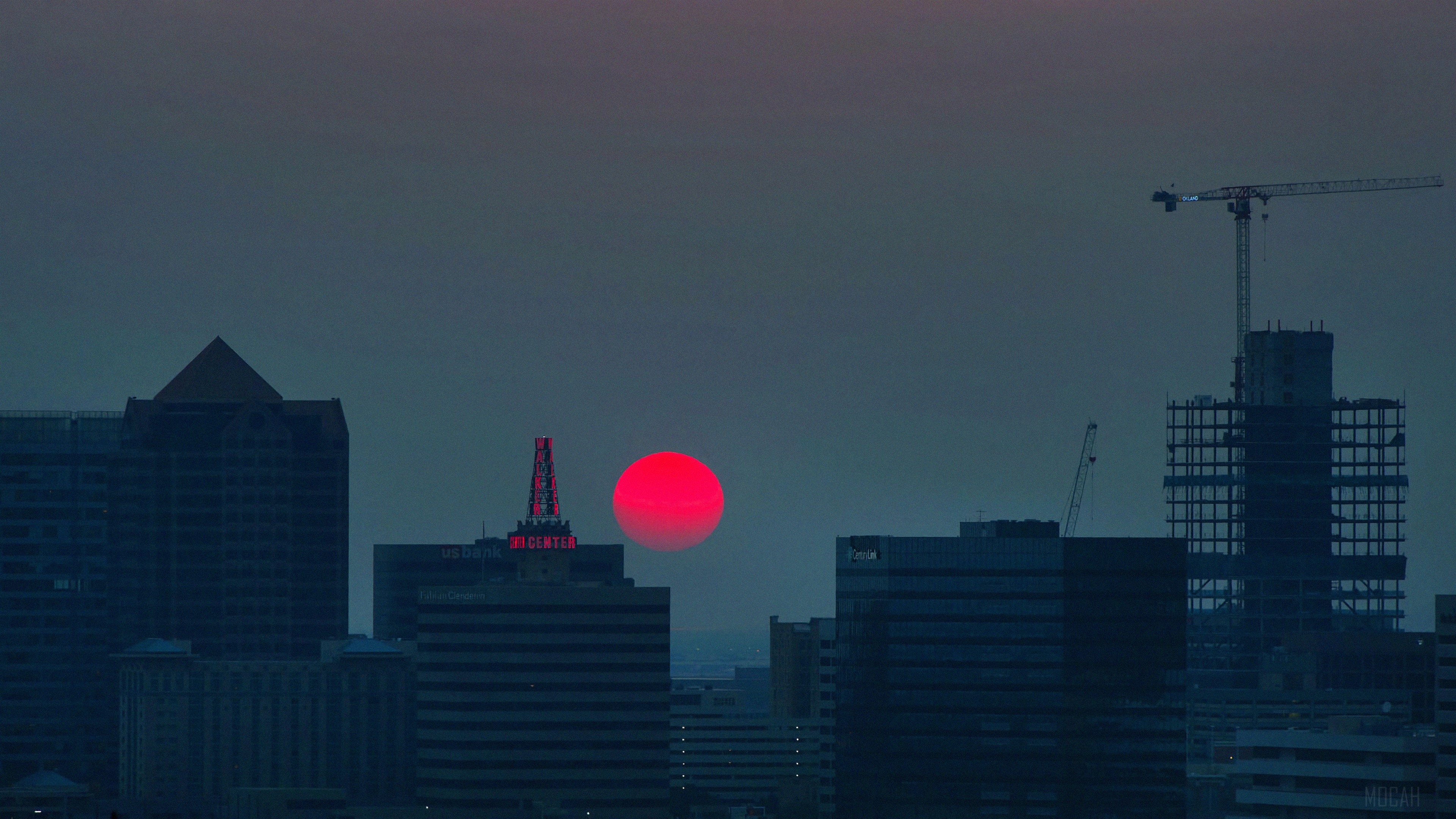 Red Sun Over City Skyline with Cranes HD Wallpaper