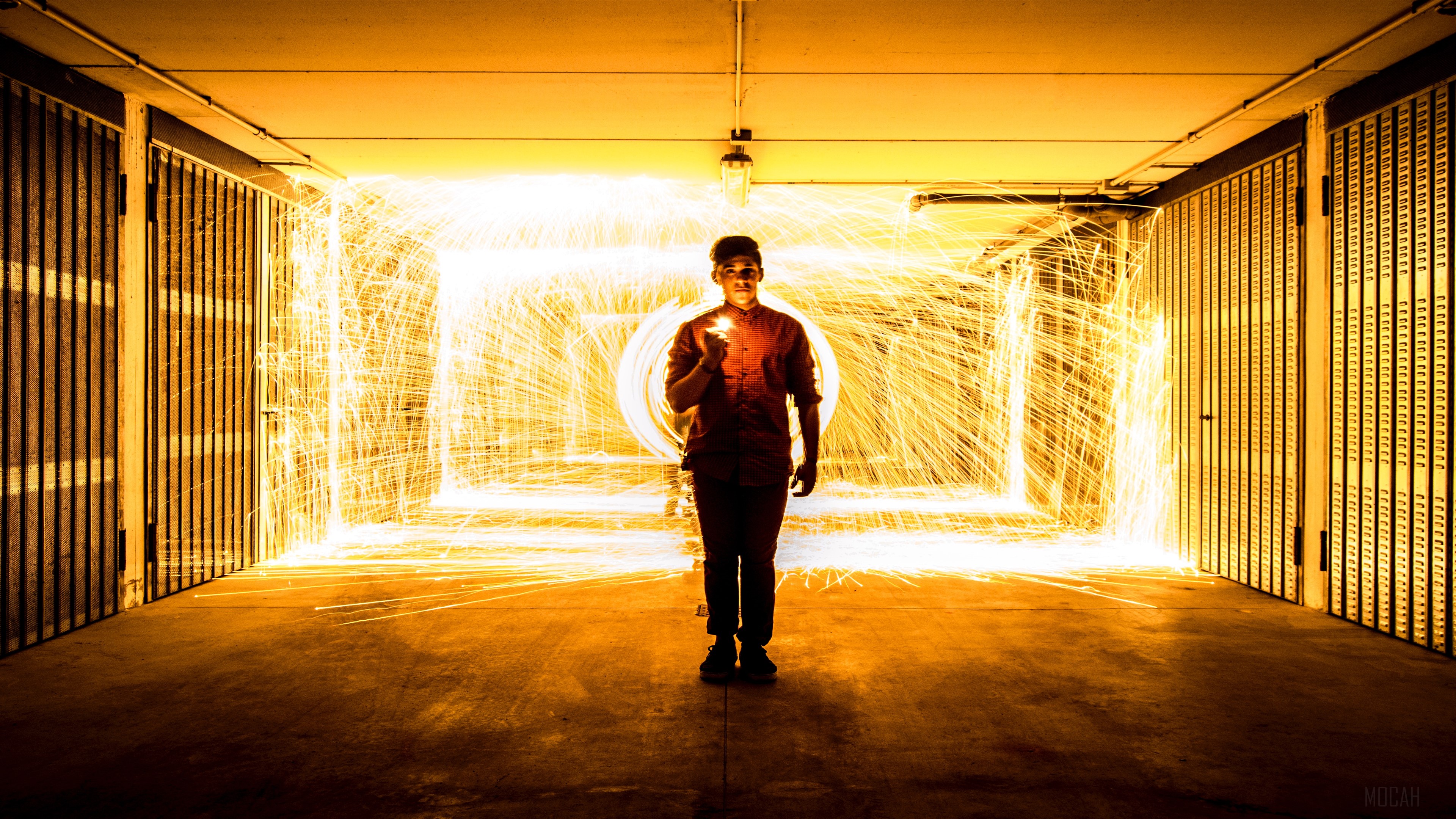 Man with fire sparks in a garage HD Wallpaper