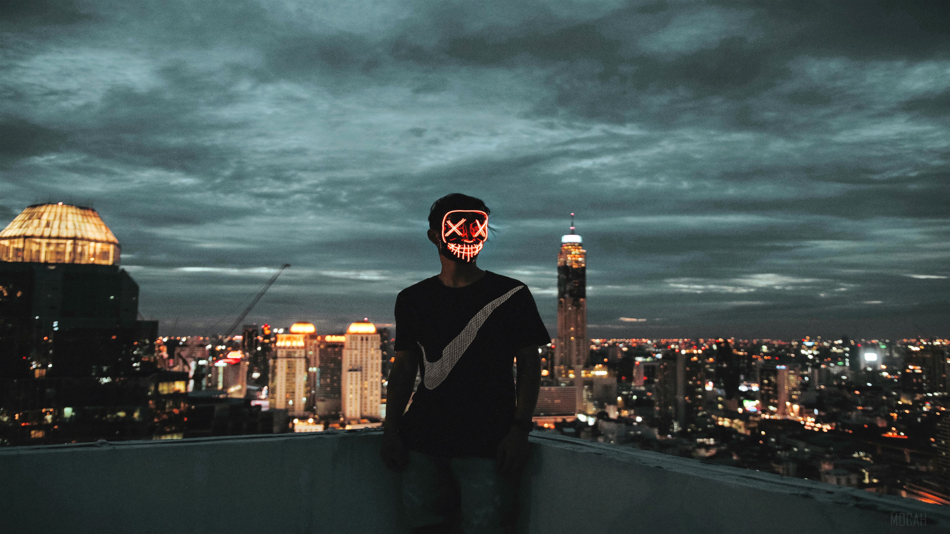 Man in Neon Mask on Rooftop Overlooking City HD Wallpaper