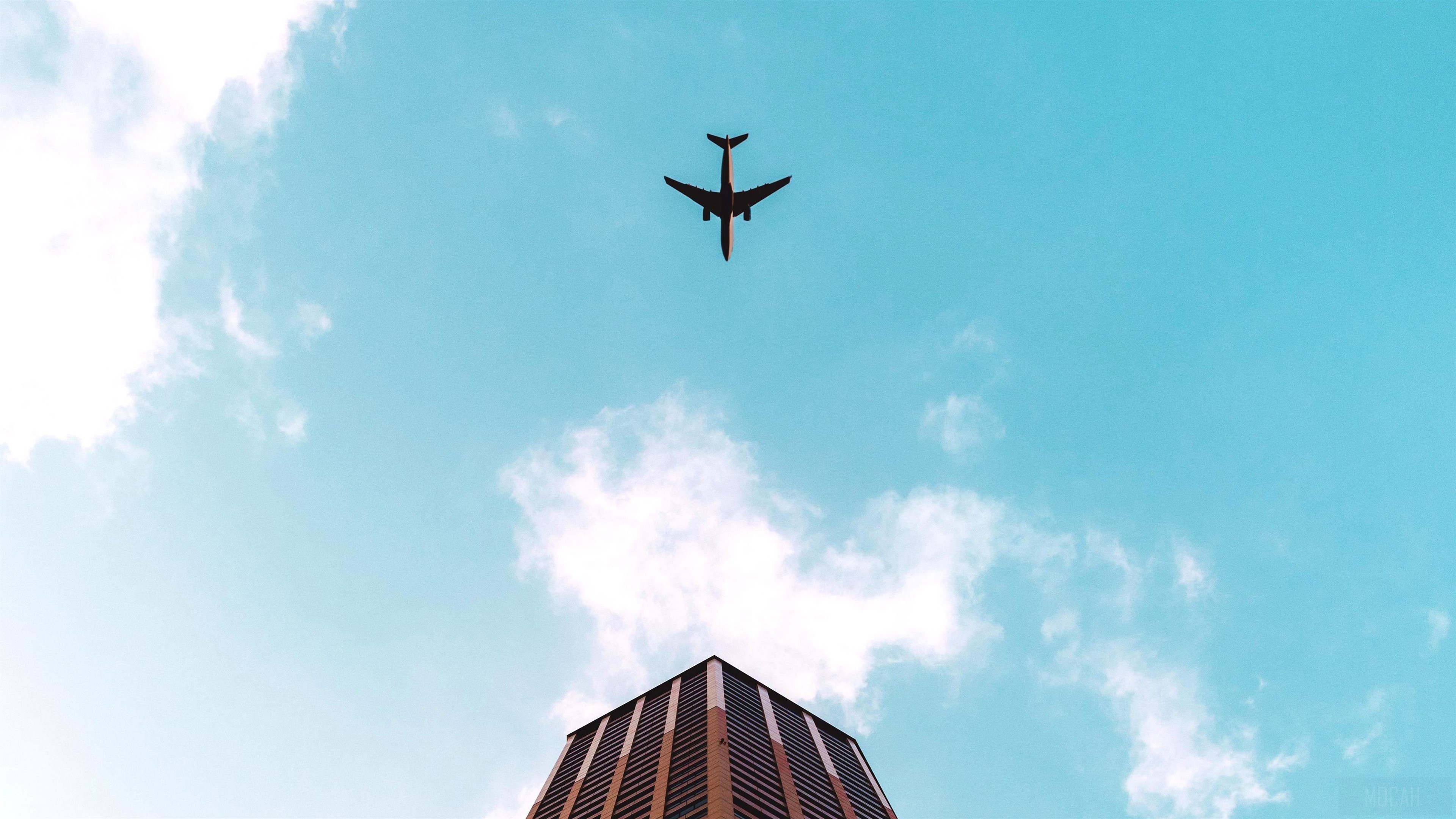 Airplane Flying Over Building 4K HD Wallpaper