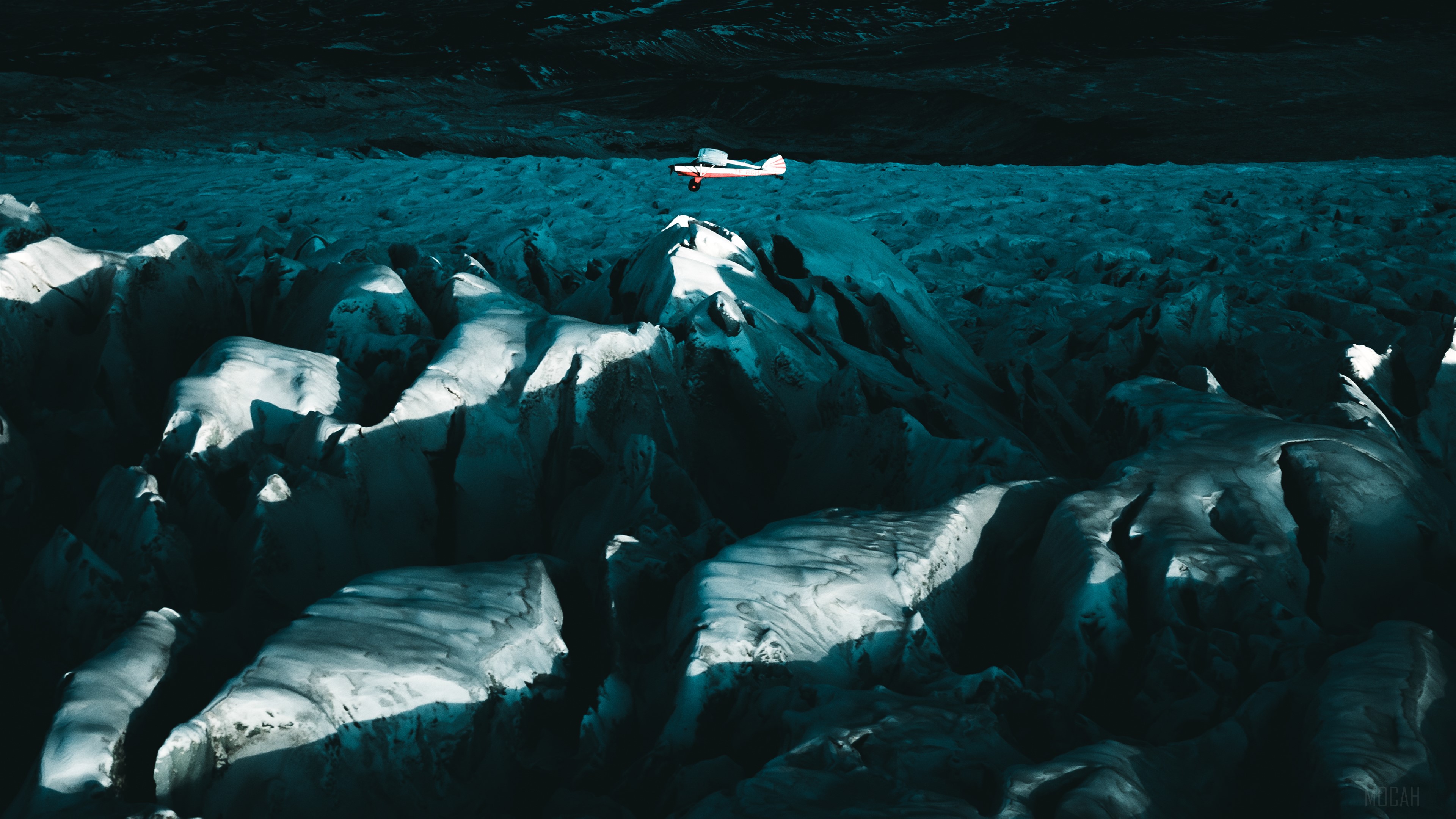 Plane Flying Above Glacial Mountains 4K HD Wallpaper