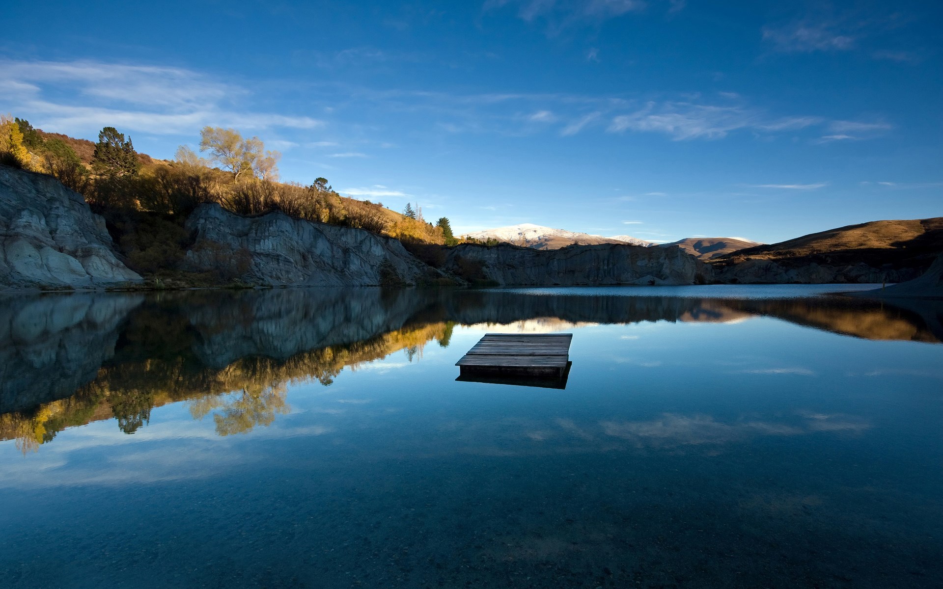 Wooden platform on a calm lake with reflections HD Wallpaper