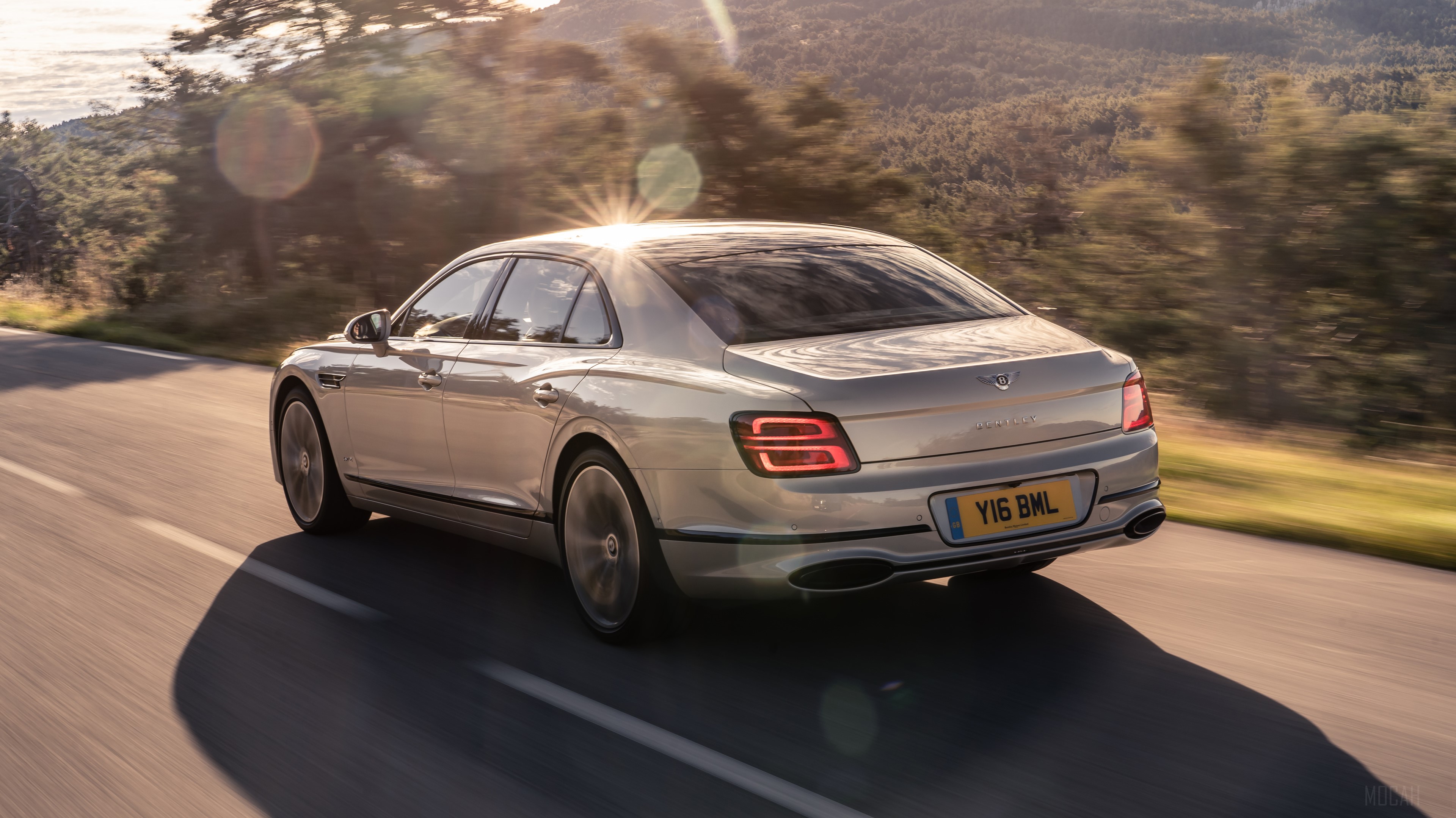 Bentley Flying Spur Blackline driving on a road HD Wallpaper