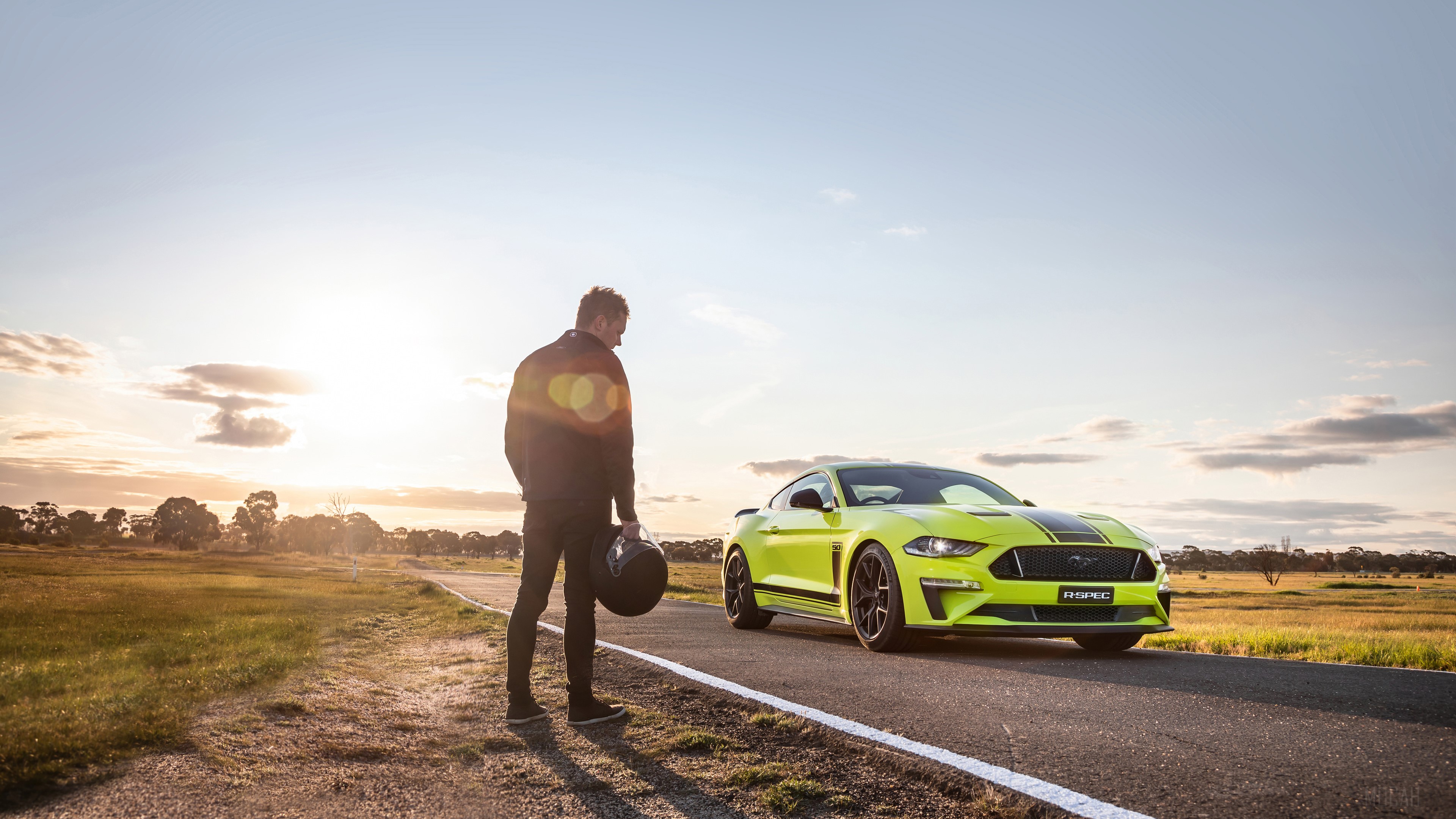 Man with helmet and yellow Ford Mustang on road HD Wallpaper