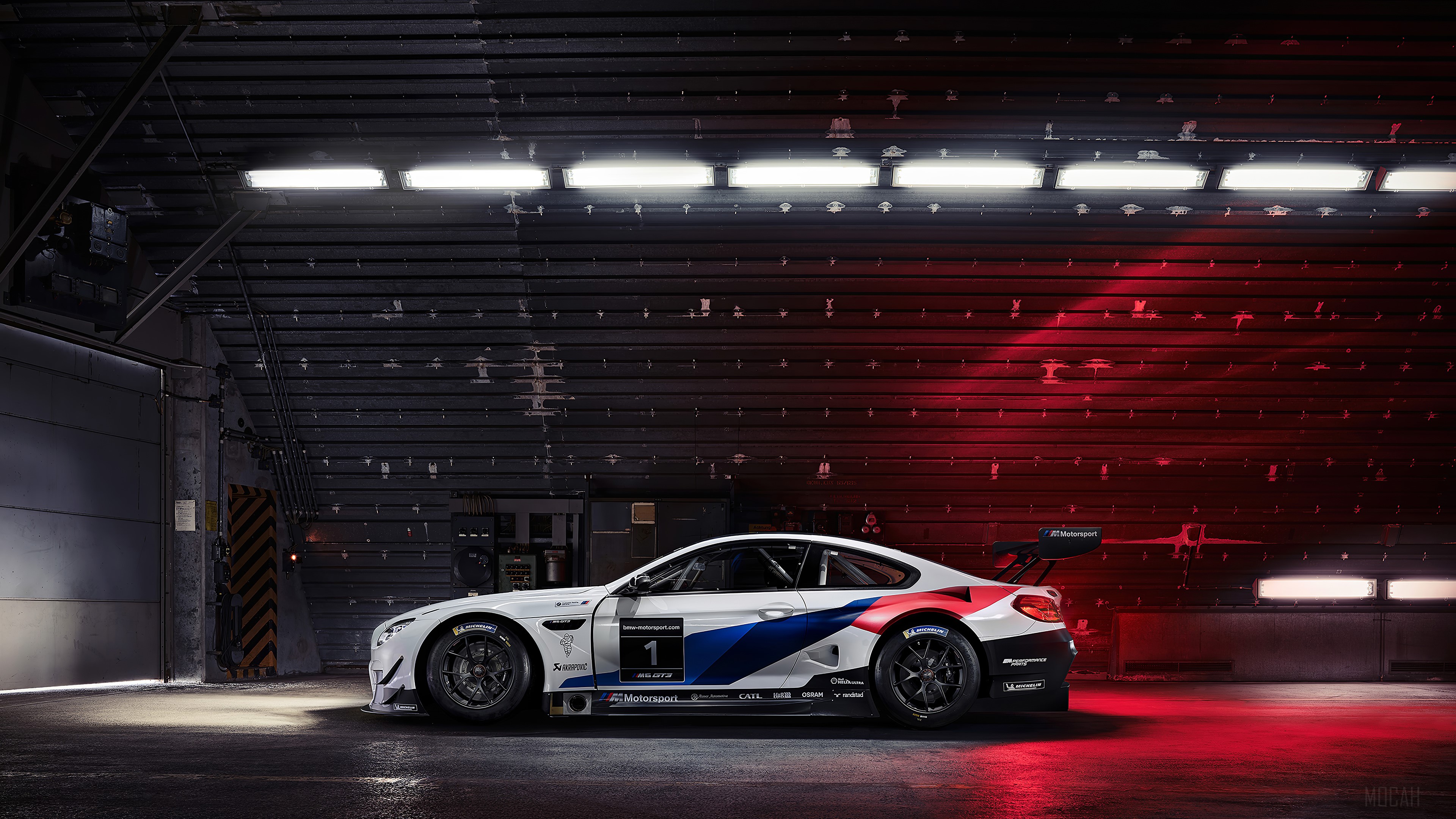 BMW M4 GT3 race car in a garage HD Wallpaper