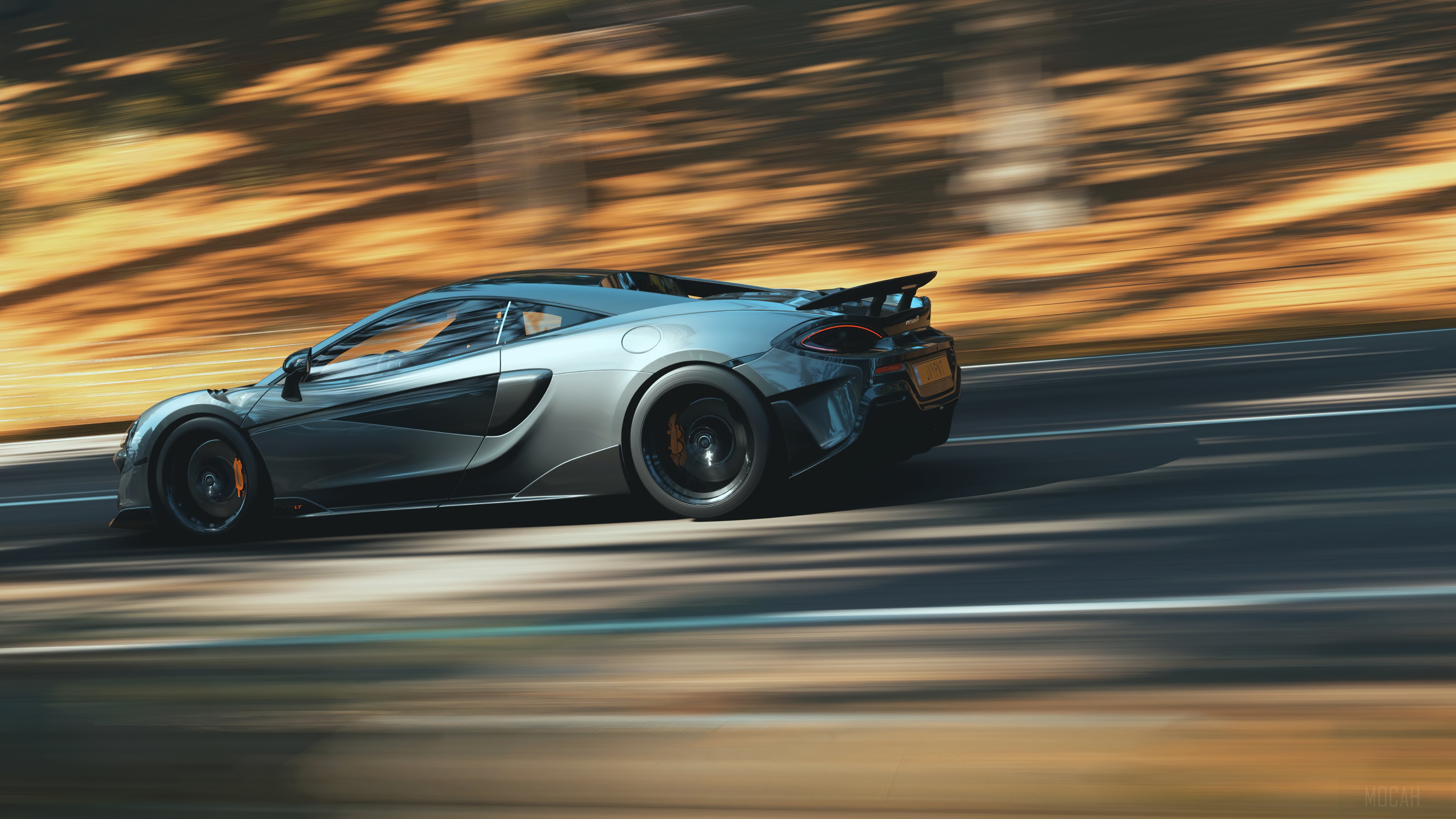 McLaren 600 LT driving on a road HD Wallpaper