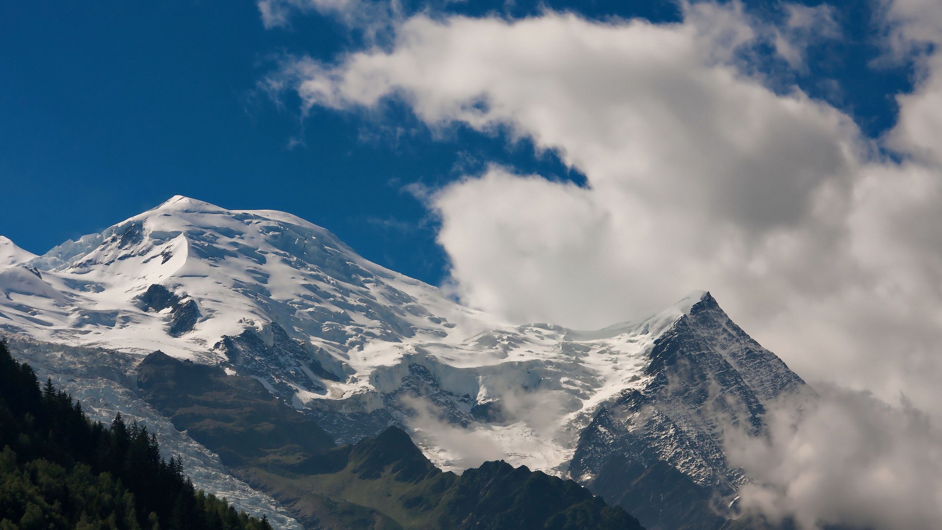 Snow-capped mountains under a blue sky with clouds HD Wallpaper