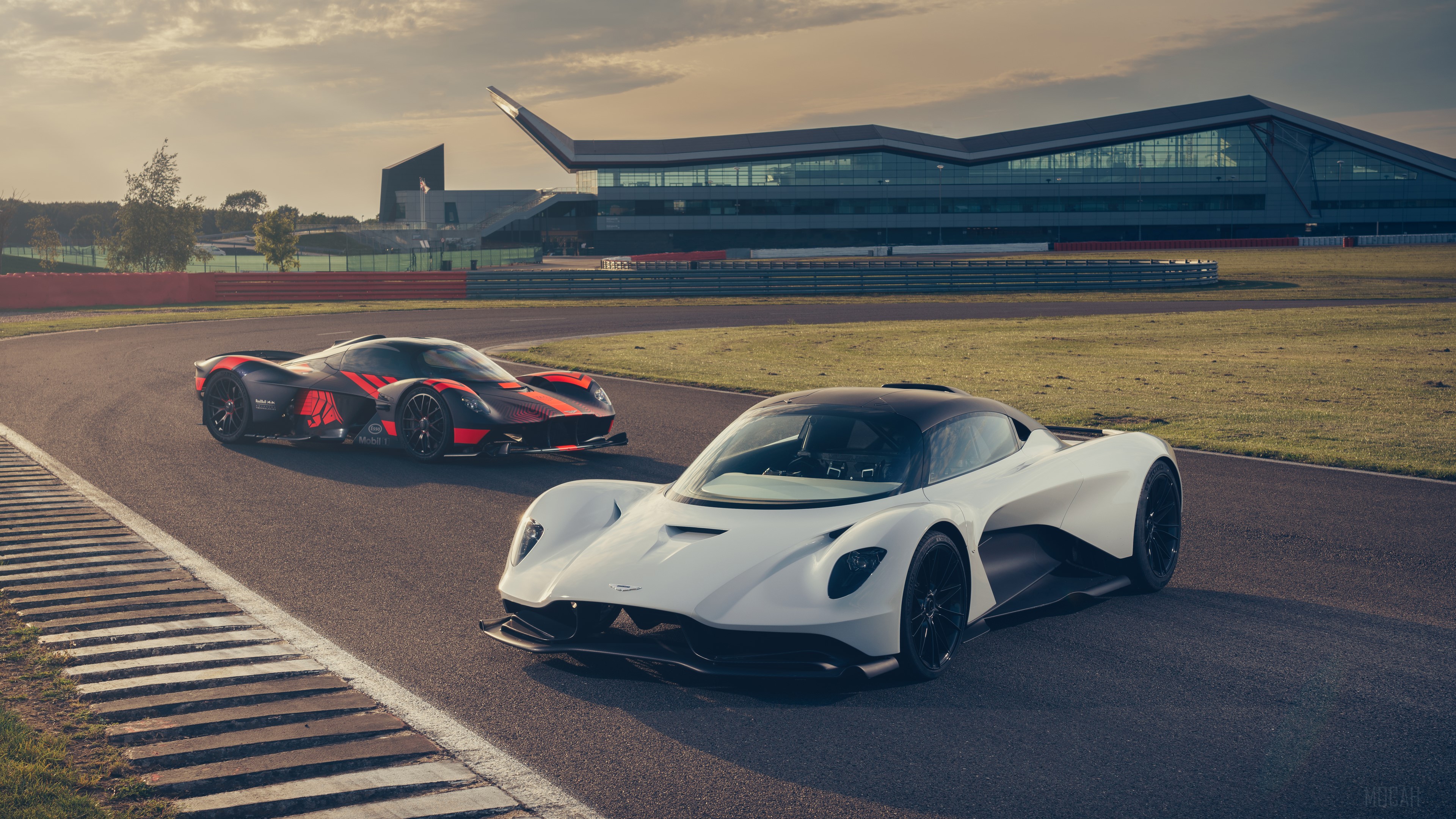 Aston Martin cars on a race track HD Wallpaper