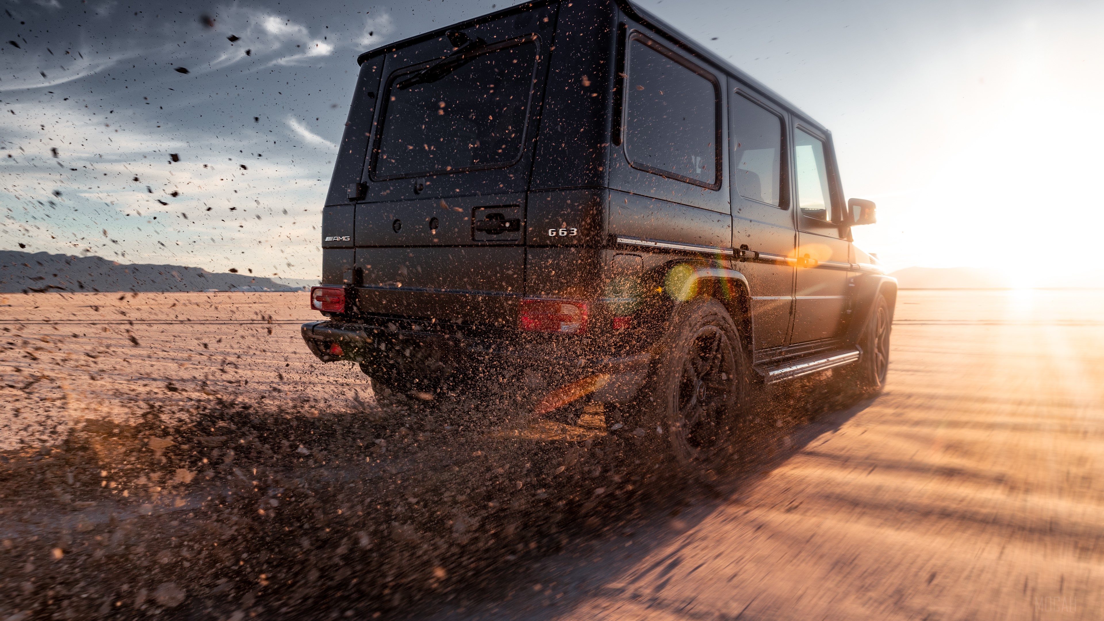 Black Mercedes-AMG G63 driving on dirt road HD Wallpaper