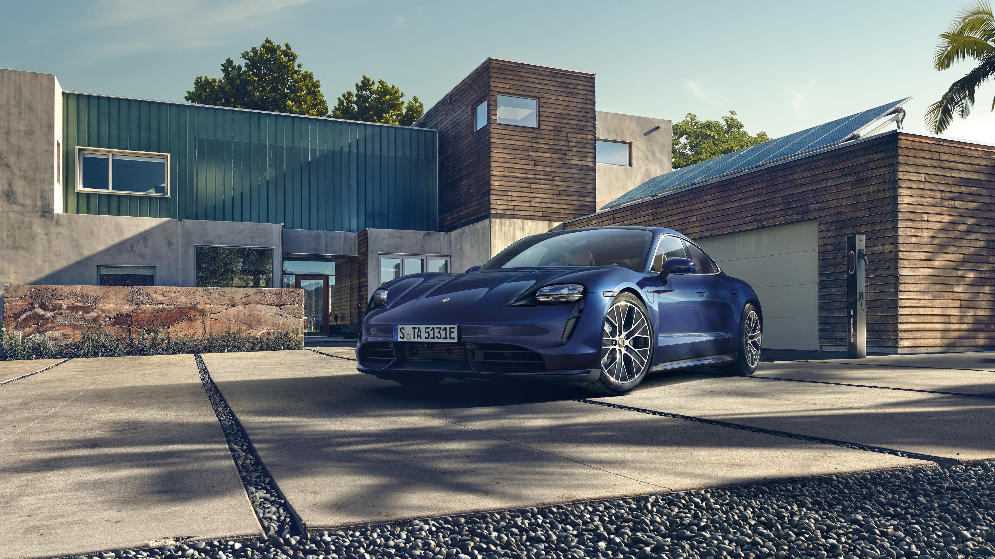Blue Porsche Taycan Turbo parked in front of modern house HD Wallpaper