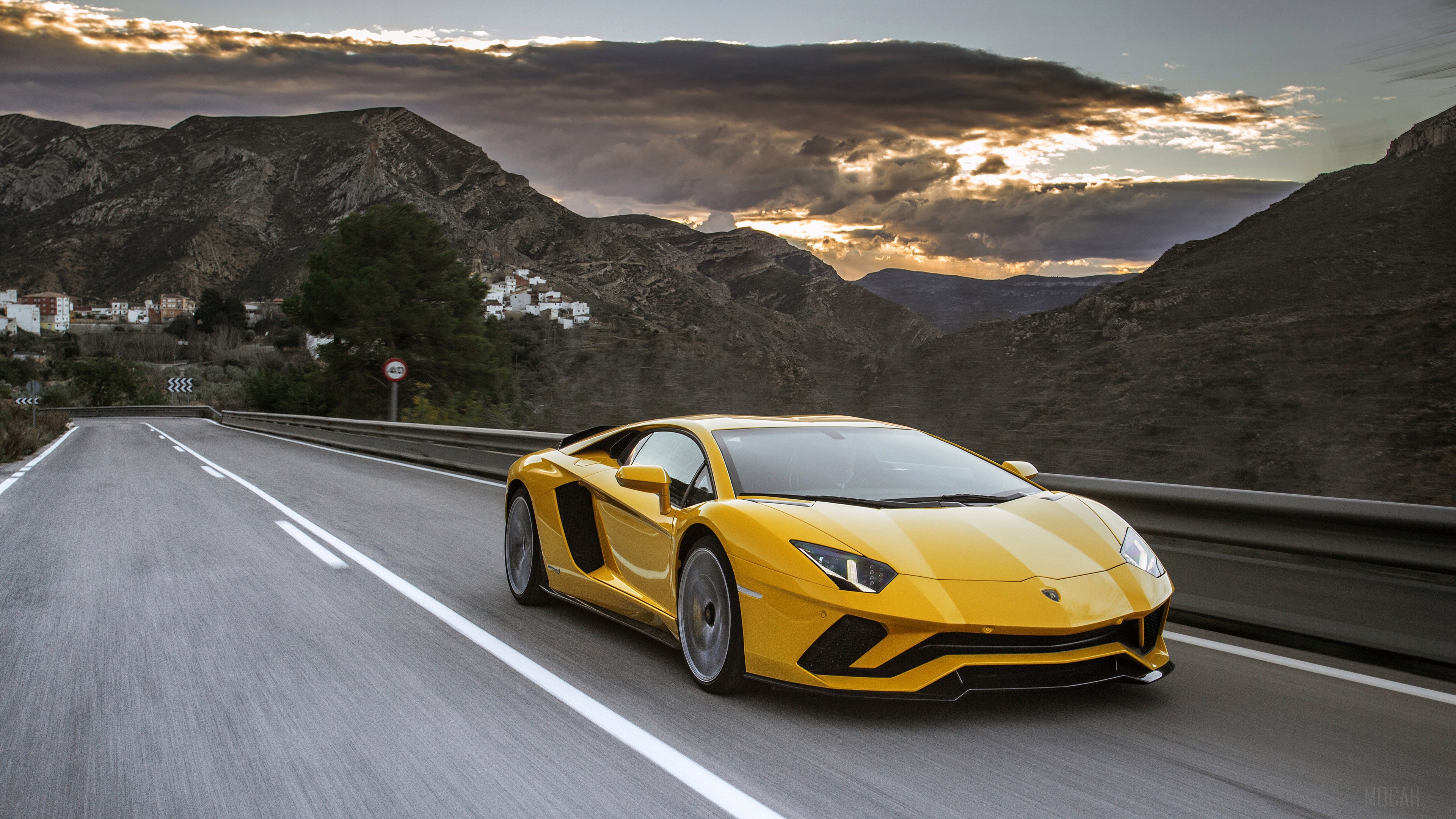 Yellow Lamborghini Aventador driving on a mountain road HD Wallpaper