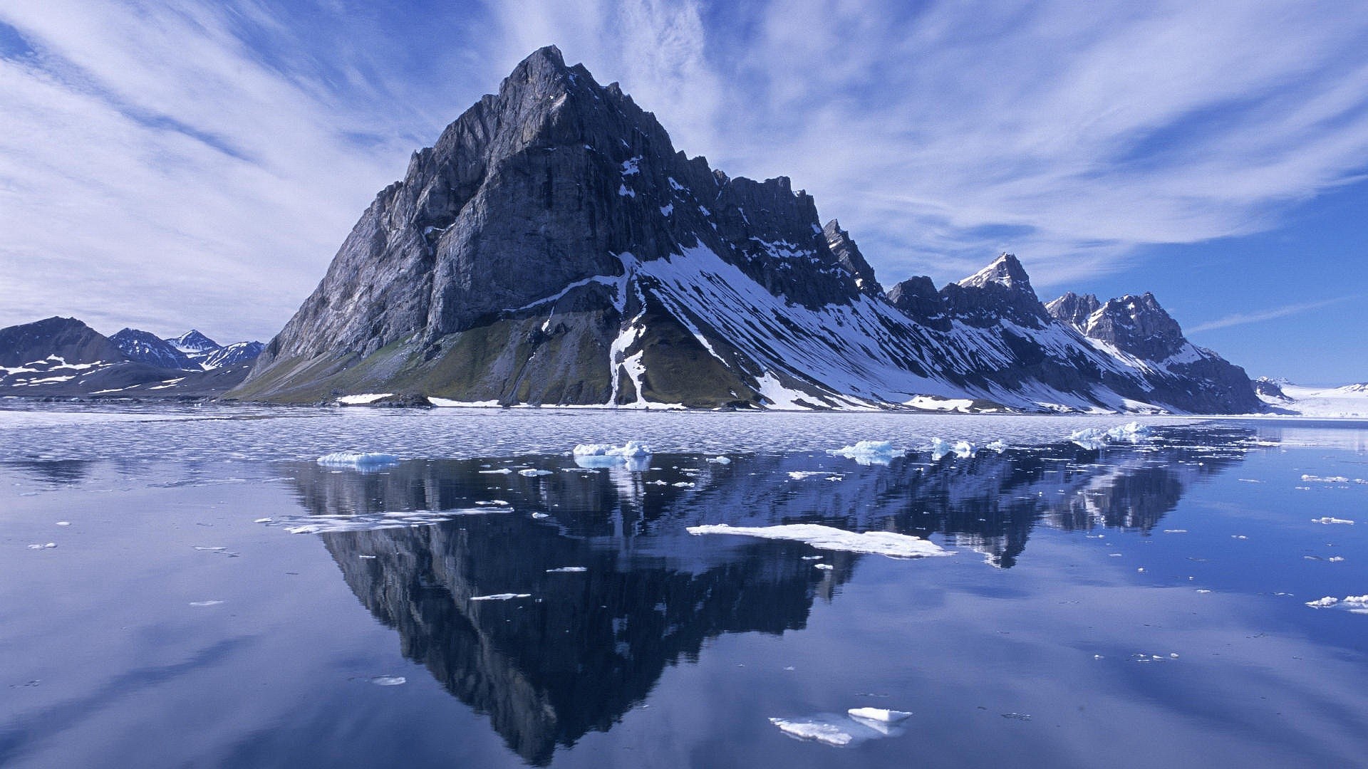 Snow-capped mountains reflected in icy water HD Wallpaper