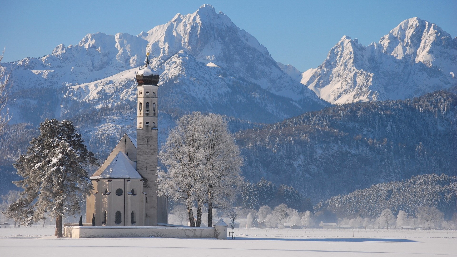 Church and snow-covered mountains in winter HD Wallpaper