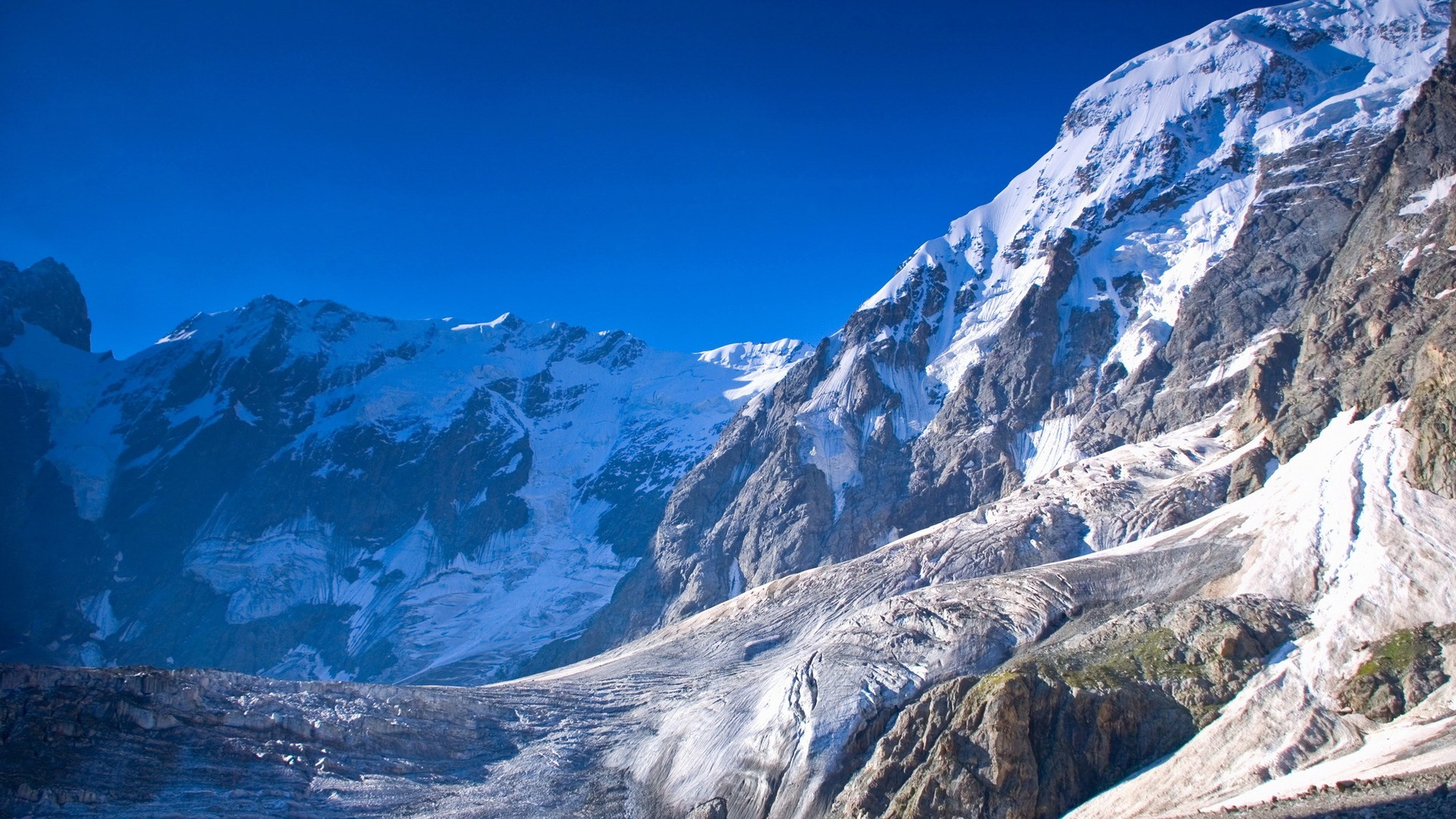 Snow-covered mountains and glacier under a clear blue sky HD Wallpaper
