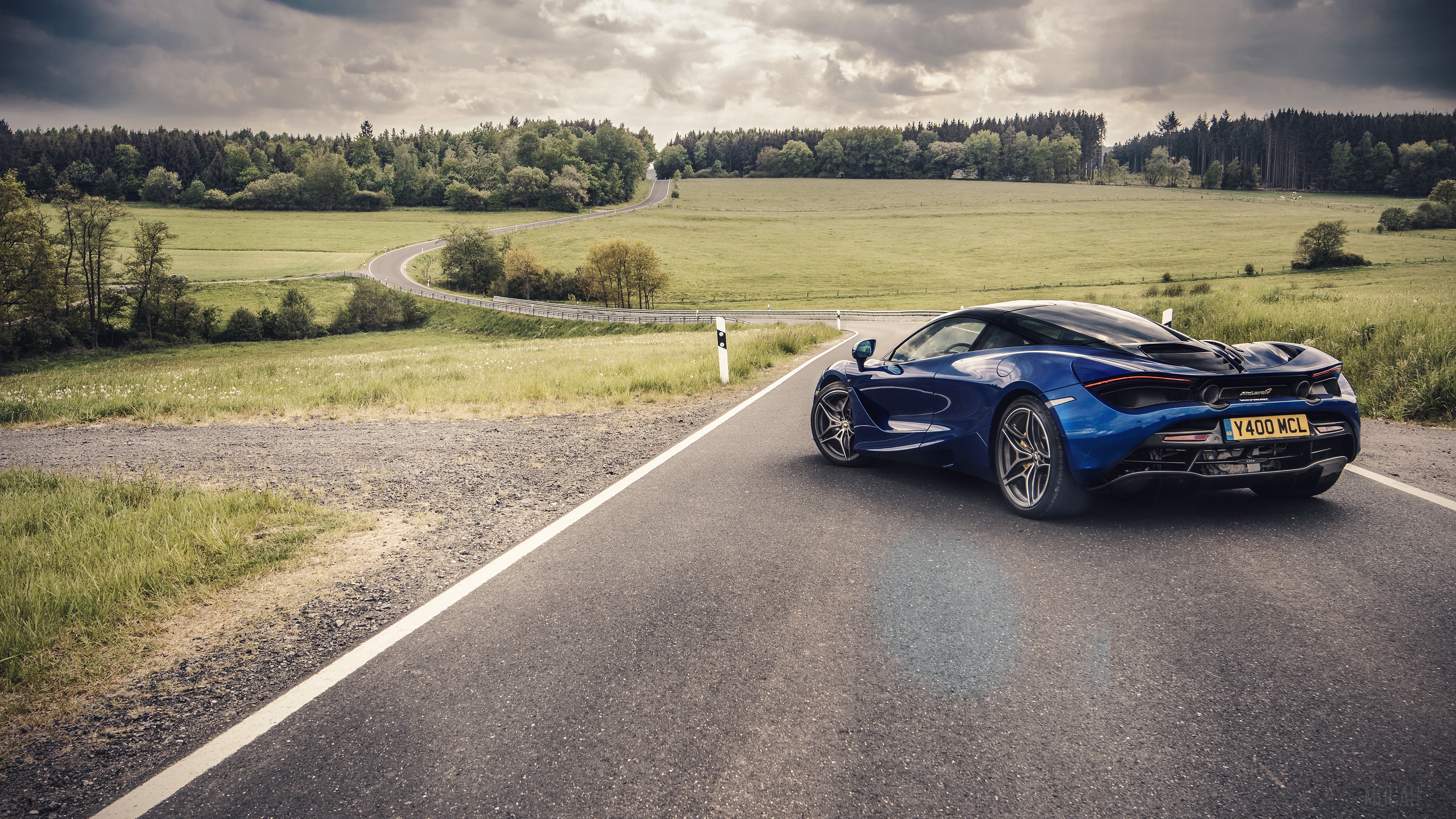 Blue McLaren 720S on a winding road HD Wallpaper