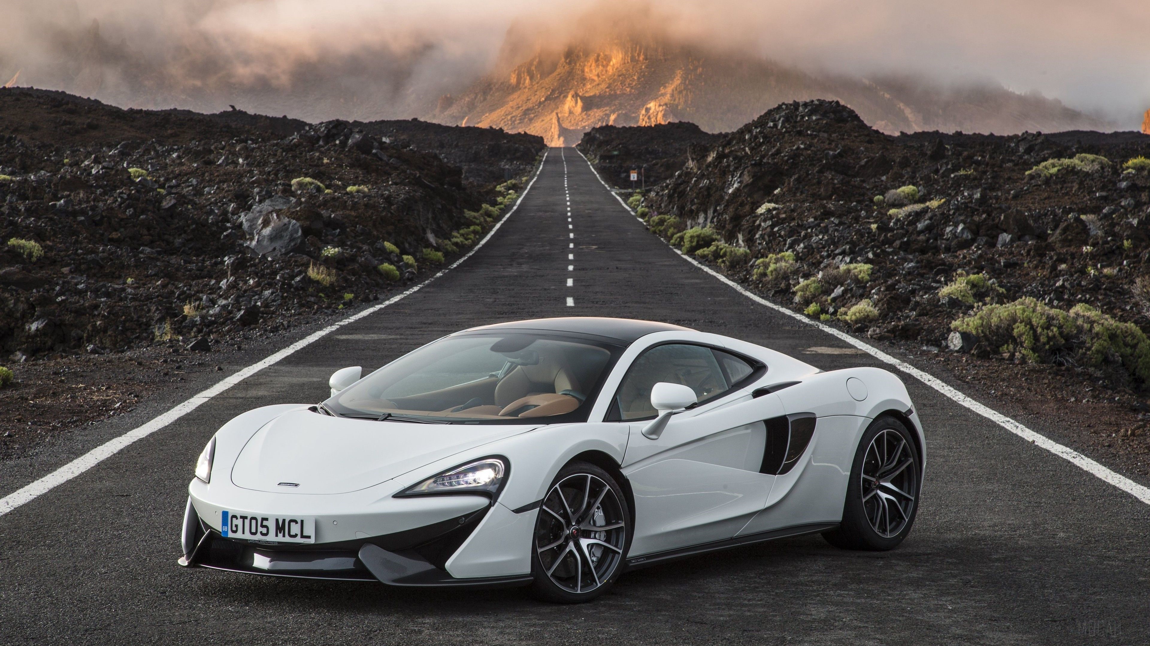 White McLaren 570S Spider on a road HD Wallpaper