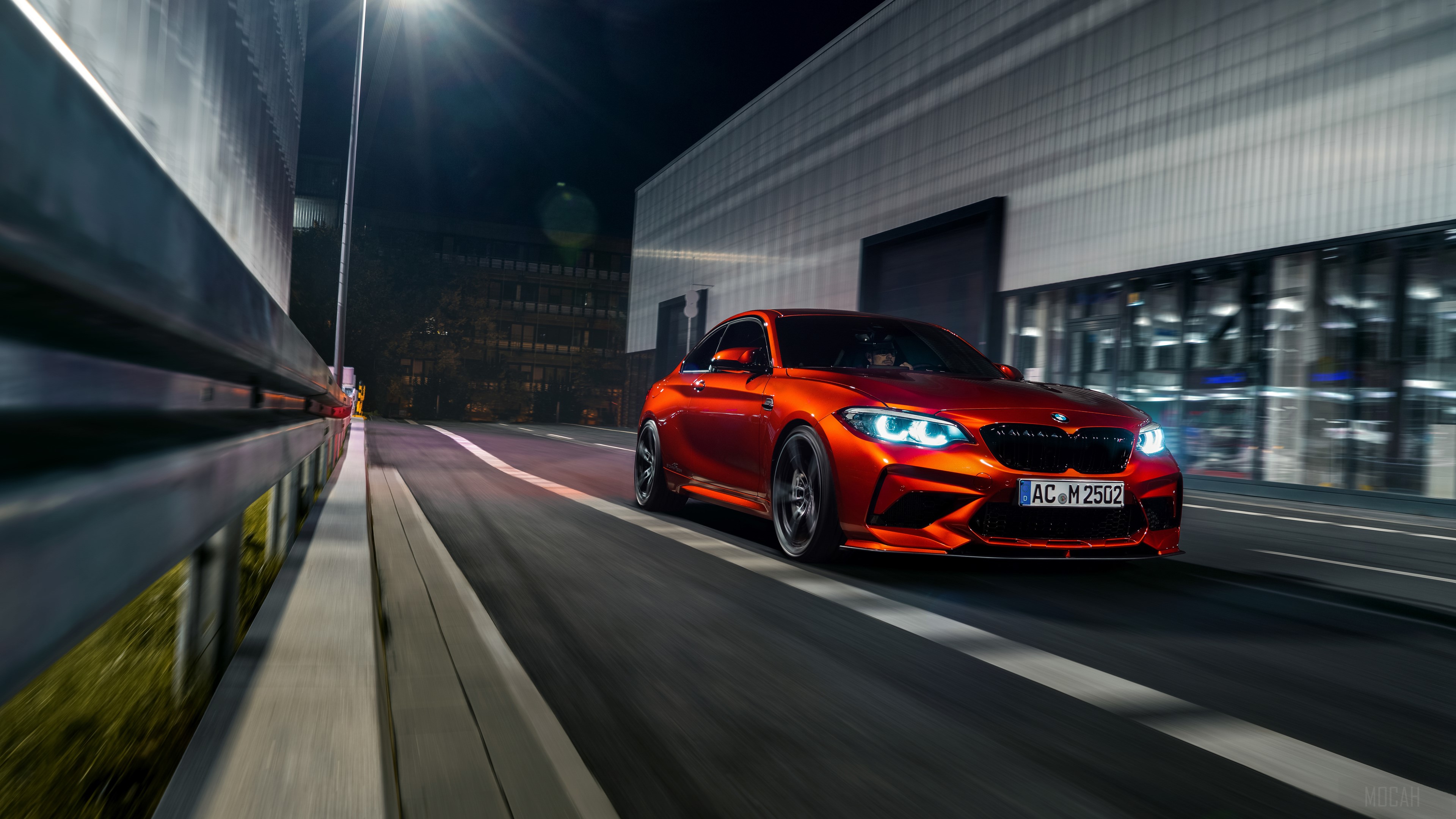 Orange BMW M2 driving at night HD Wallpaper