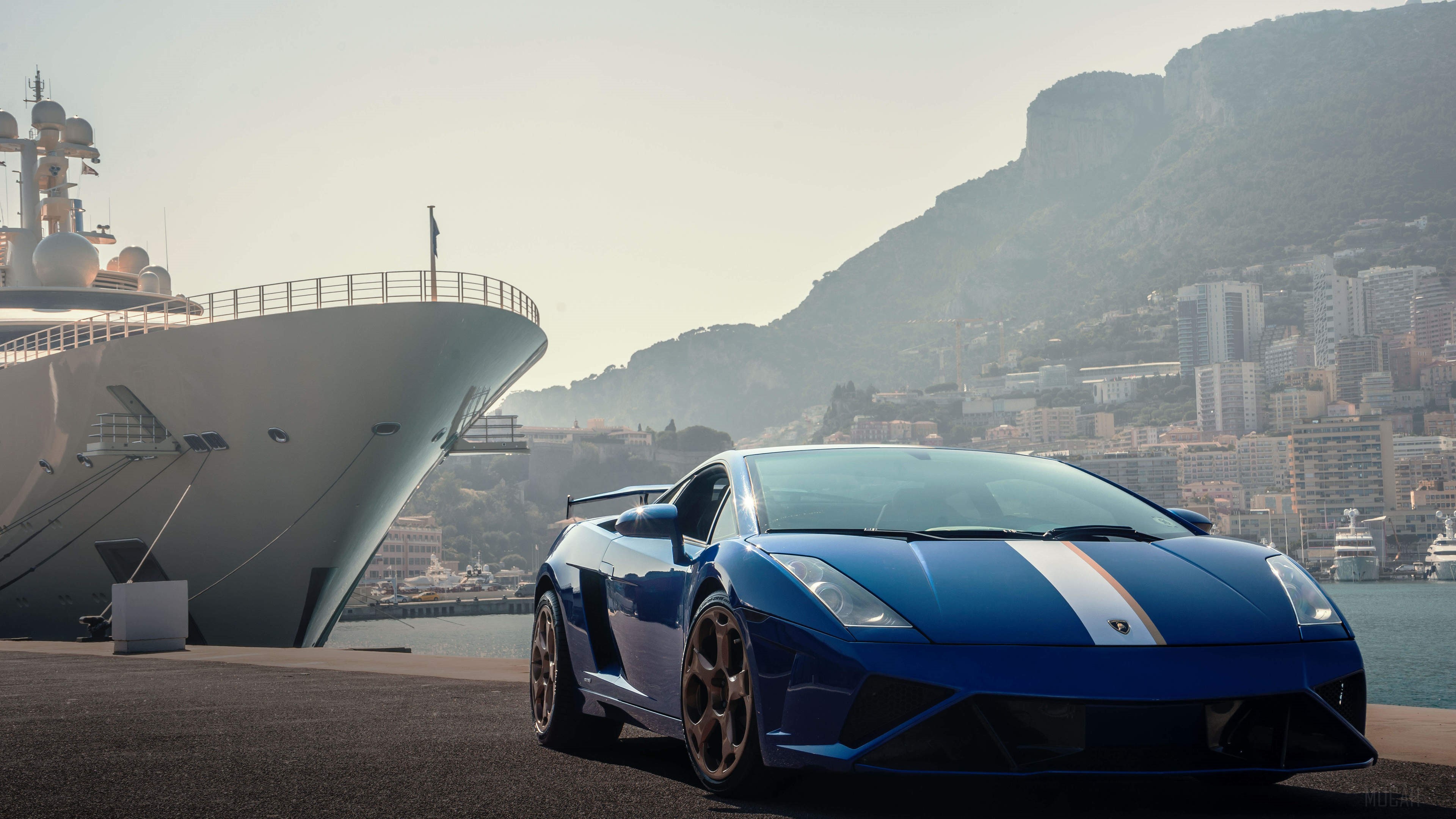 Blue Lamborghini Gallardo parked by a yacht and city HD Wallpaper