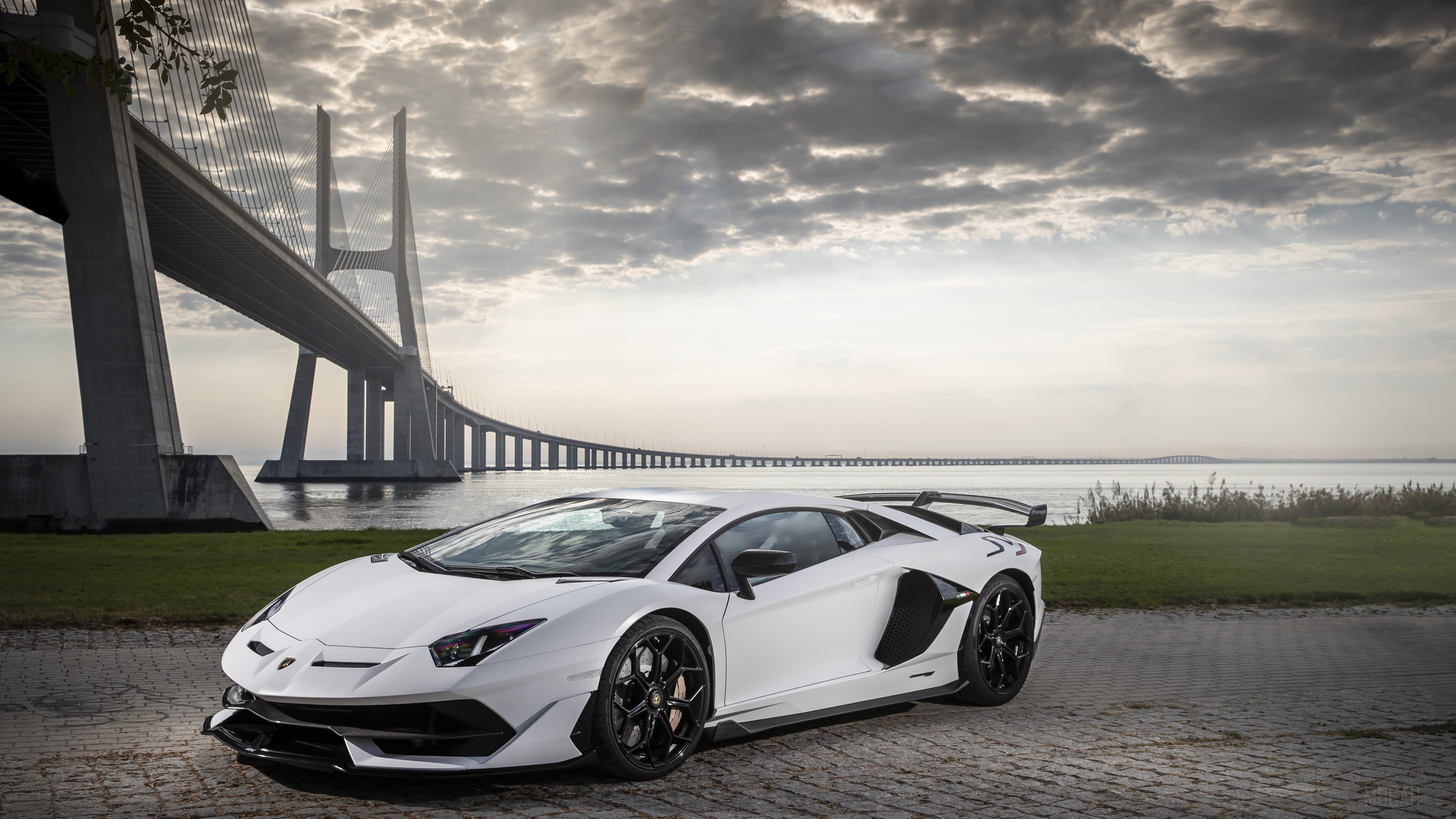 White Lamborghini Aventador SVJ 4K near Vasco da Gama Bridge HD Wallpaper