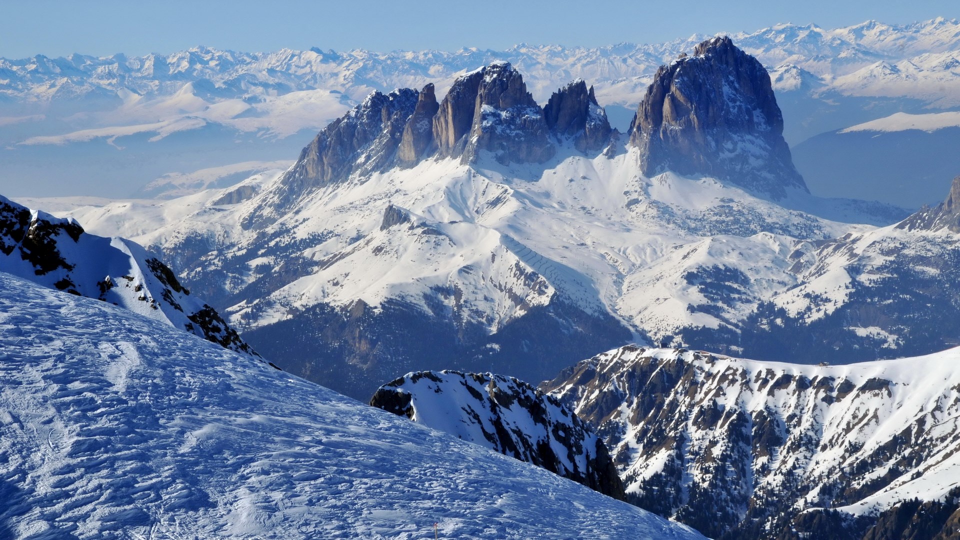 Snow-covered mountains under a clear blue sky HD Wallpaper