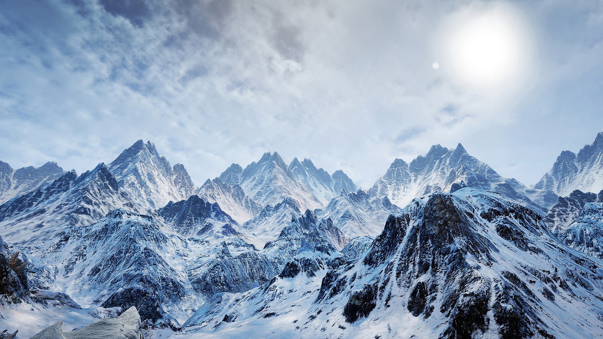 Snow-covered mountains under a bright sun and cloudy sky HD Wallpaper