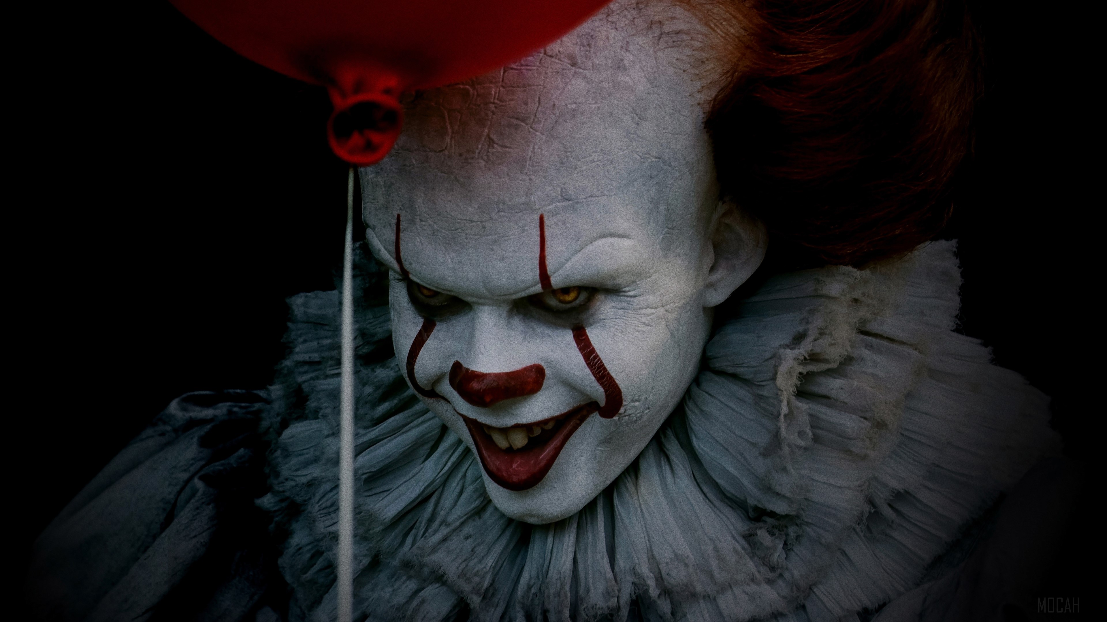 Pennywise from It holding a red balloon in 4K HD Wallpaper