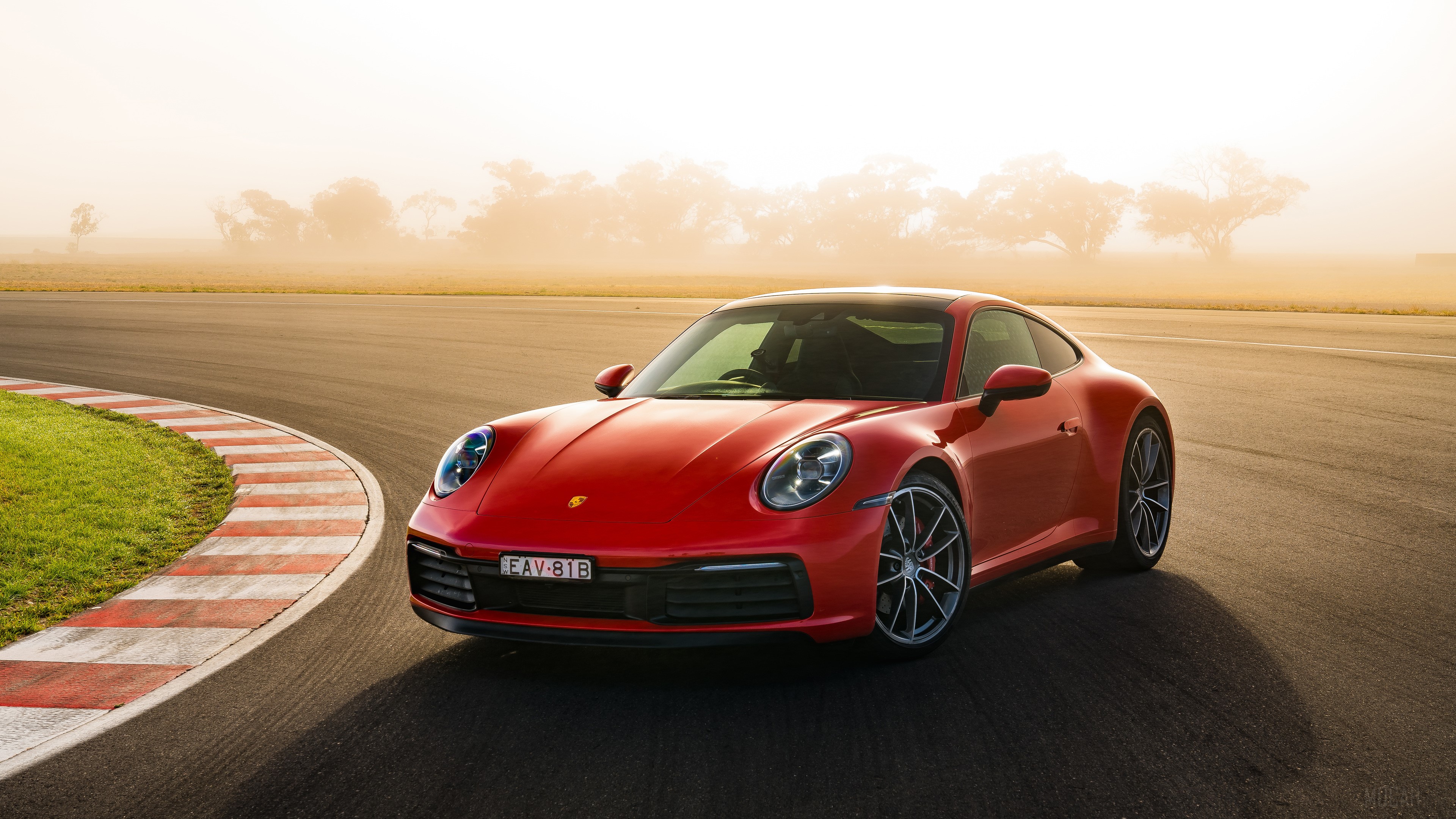 Red 2019 Porsche 911 Carrera S on a race track HD Wallpaper