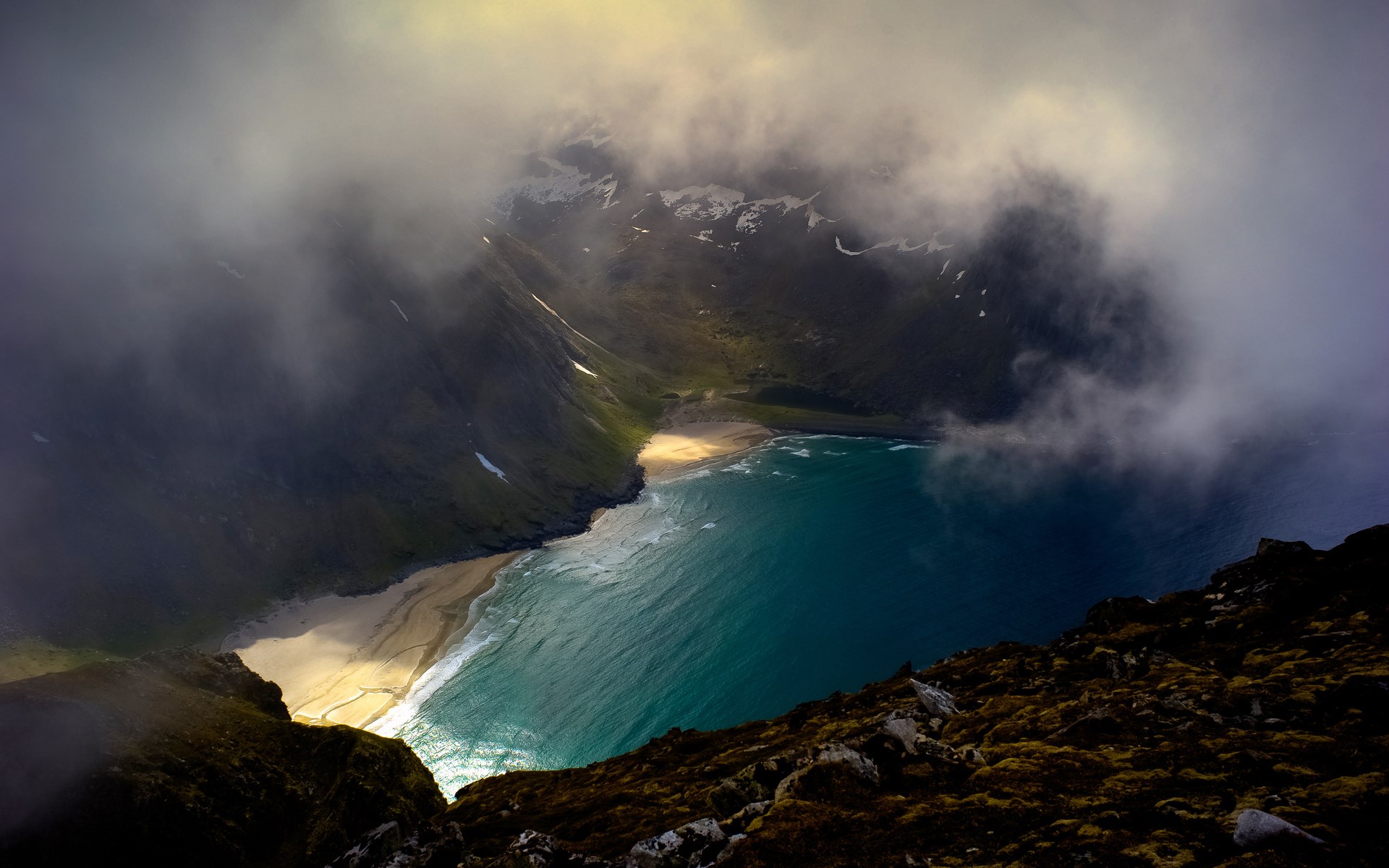 Misty mountain cove with turquoise water and sandy beach HD Wallpaper